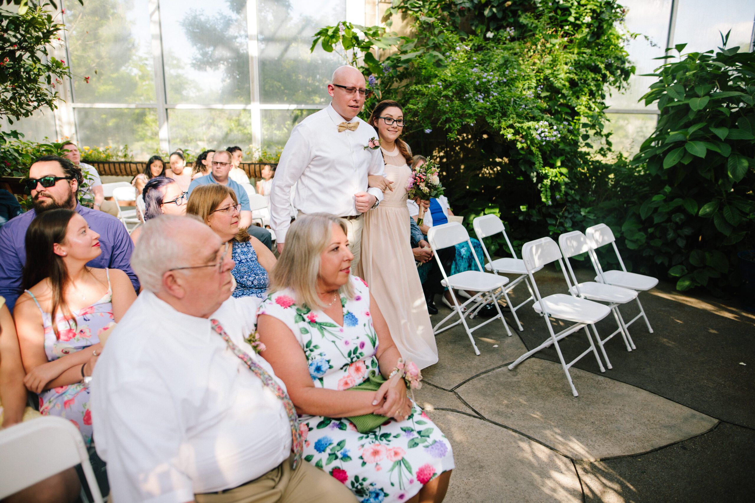 The bridal party walks down the aisle for the intimate Butterfly Pavilion wedding.