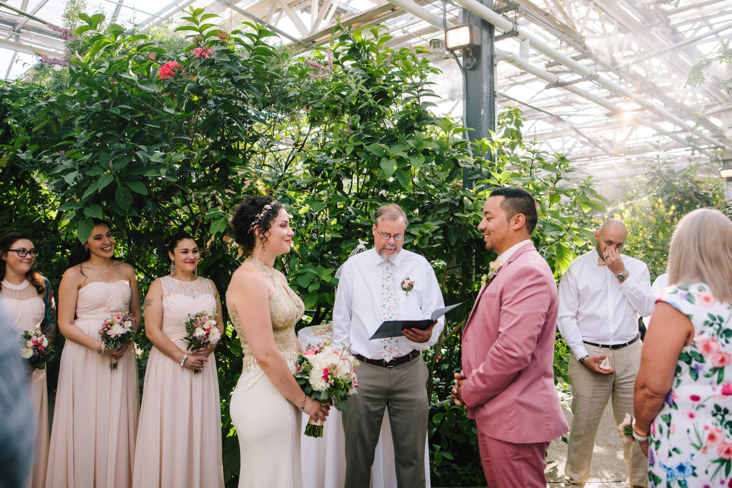 The bride and groom smiling at each other during their Butterfly Pavilion wedding. 