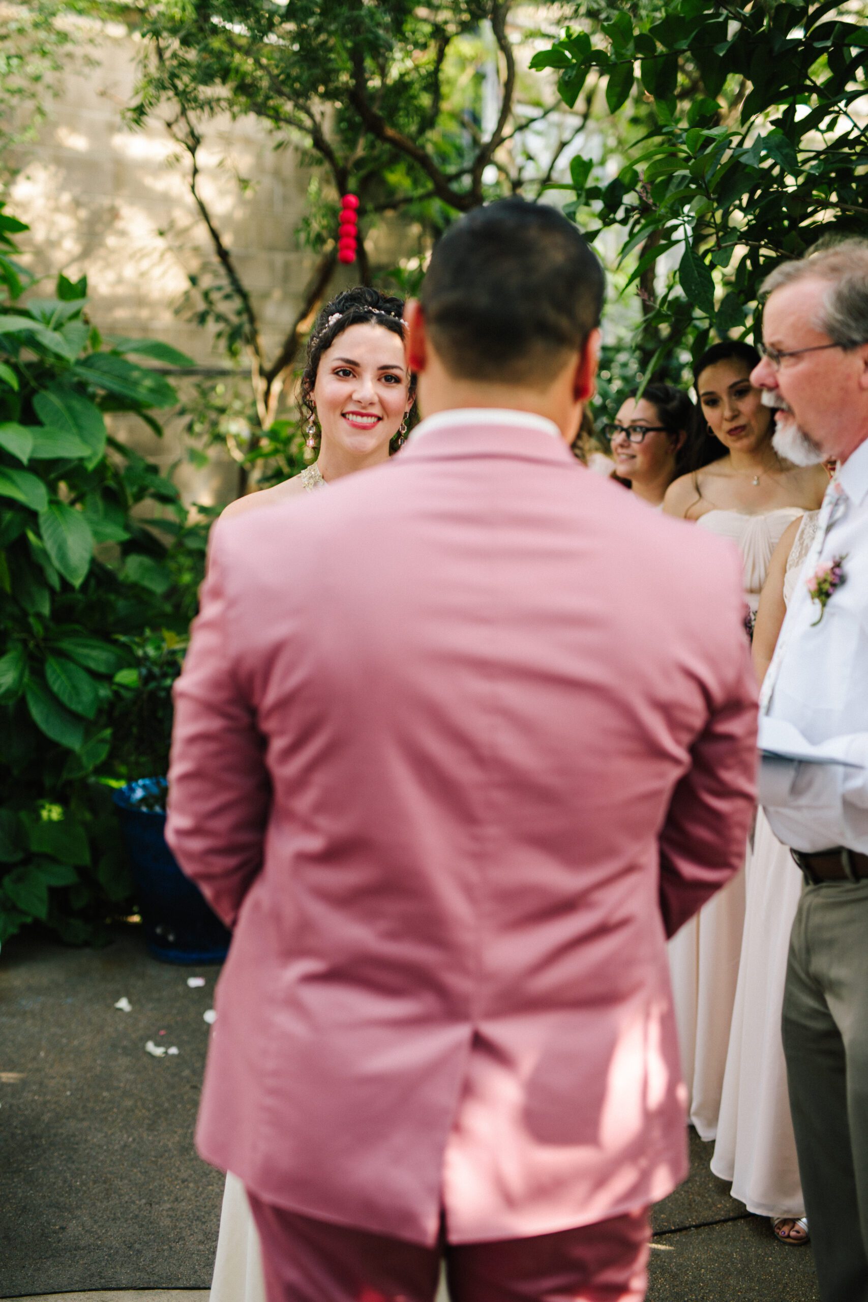 The bride looks longingly at her groom during their Butterfly Pavilion wedding.