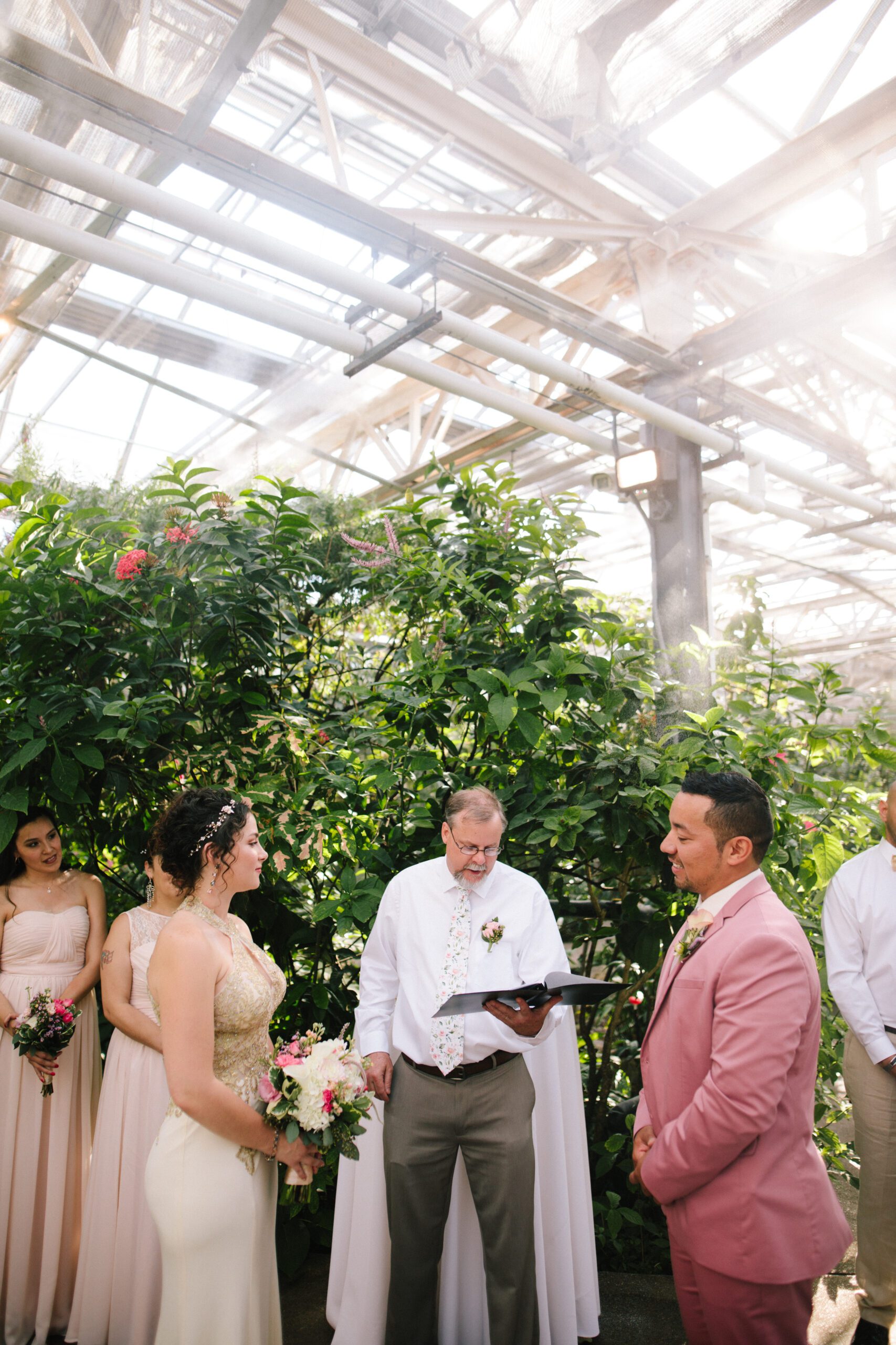 A shot of the bride and groom listening to the officint during their Butterfly Pavilion wedding.