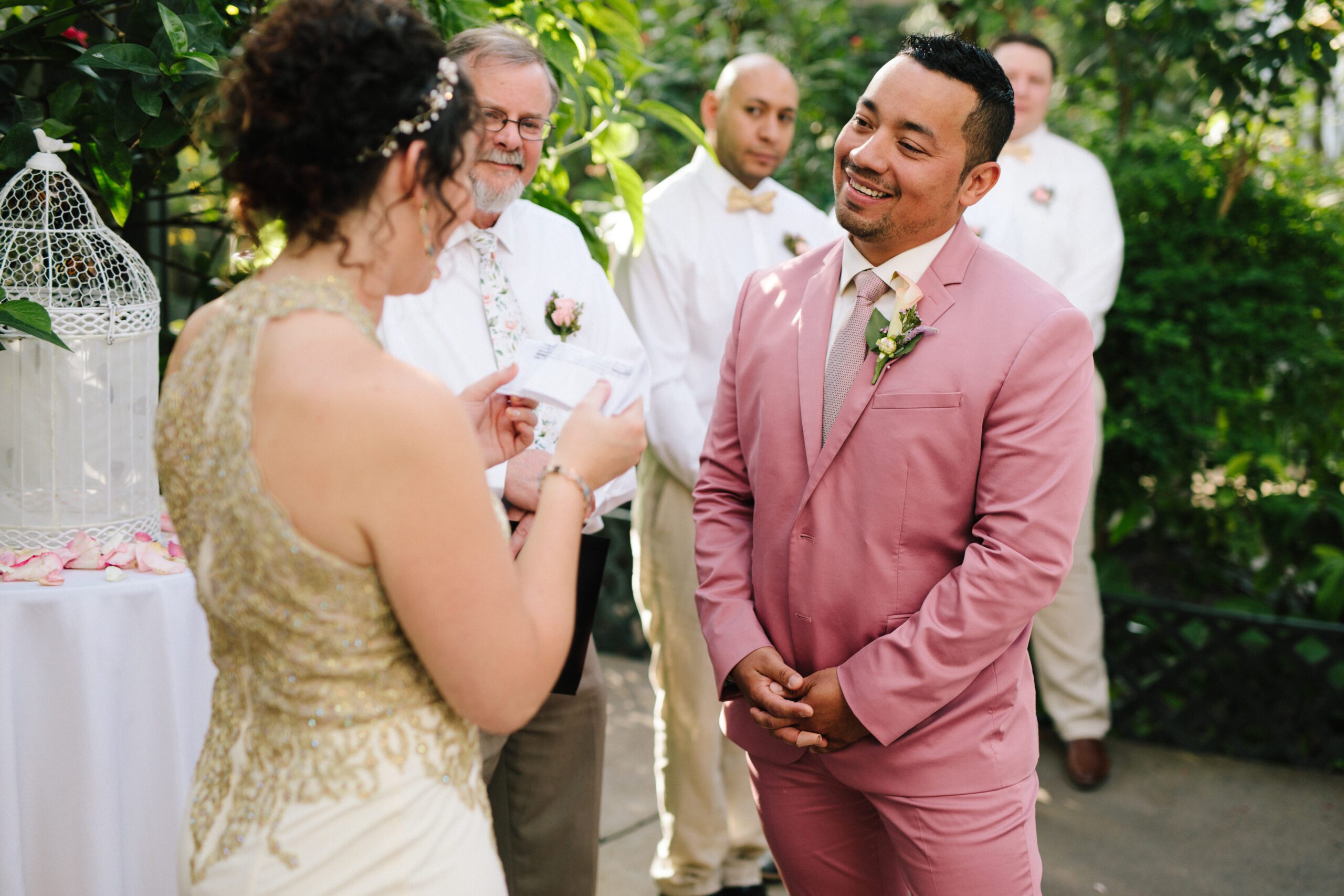 The gorgeous bride shares her vows with her groom who is smiling bright during their Butterfly Pavilion wedding. 