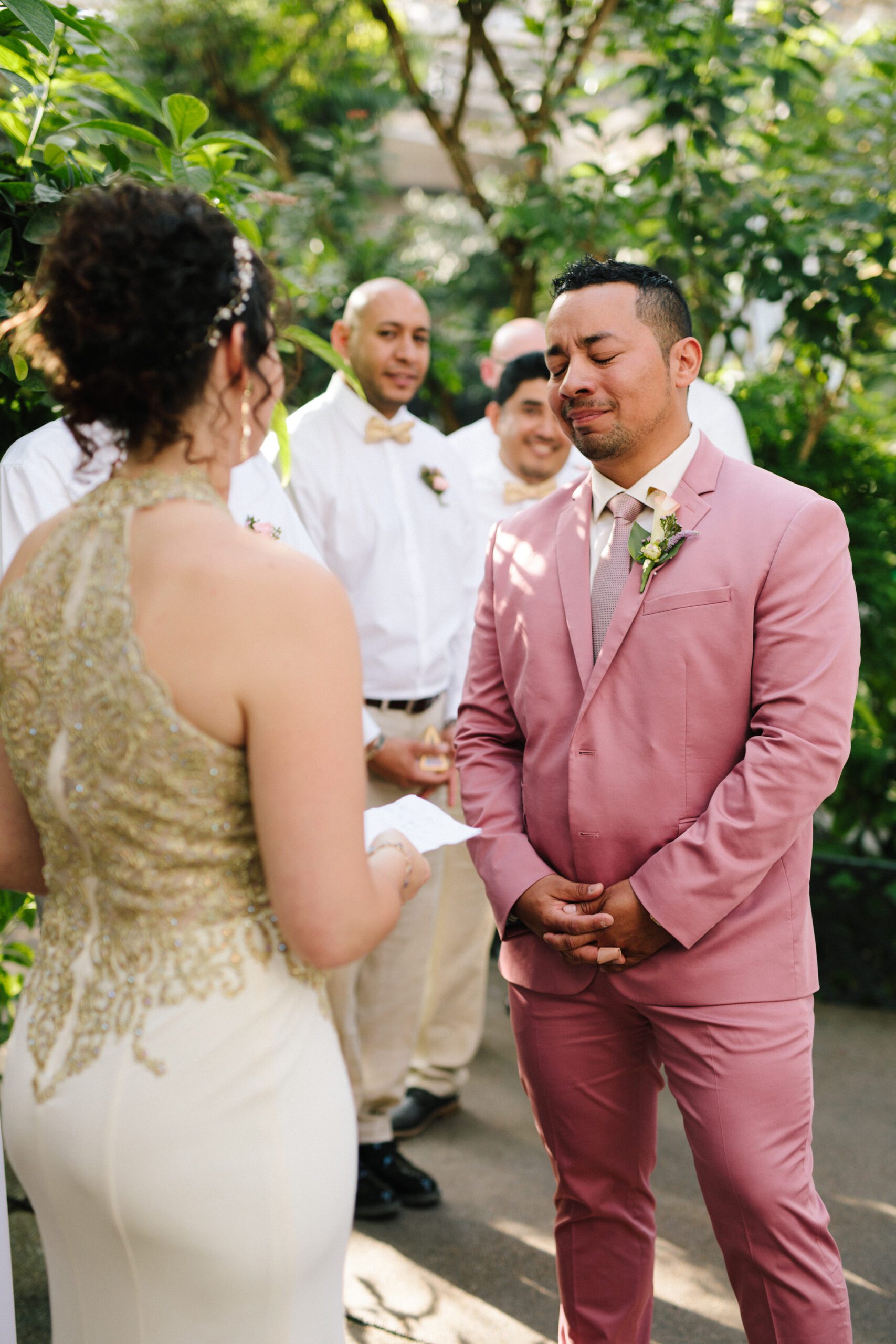 The groom getting emotional as his beautiful bride shares her vows during their ceremony at their Butterfly Pavilion wedding.