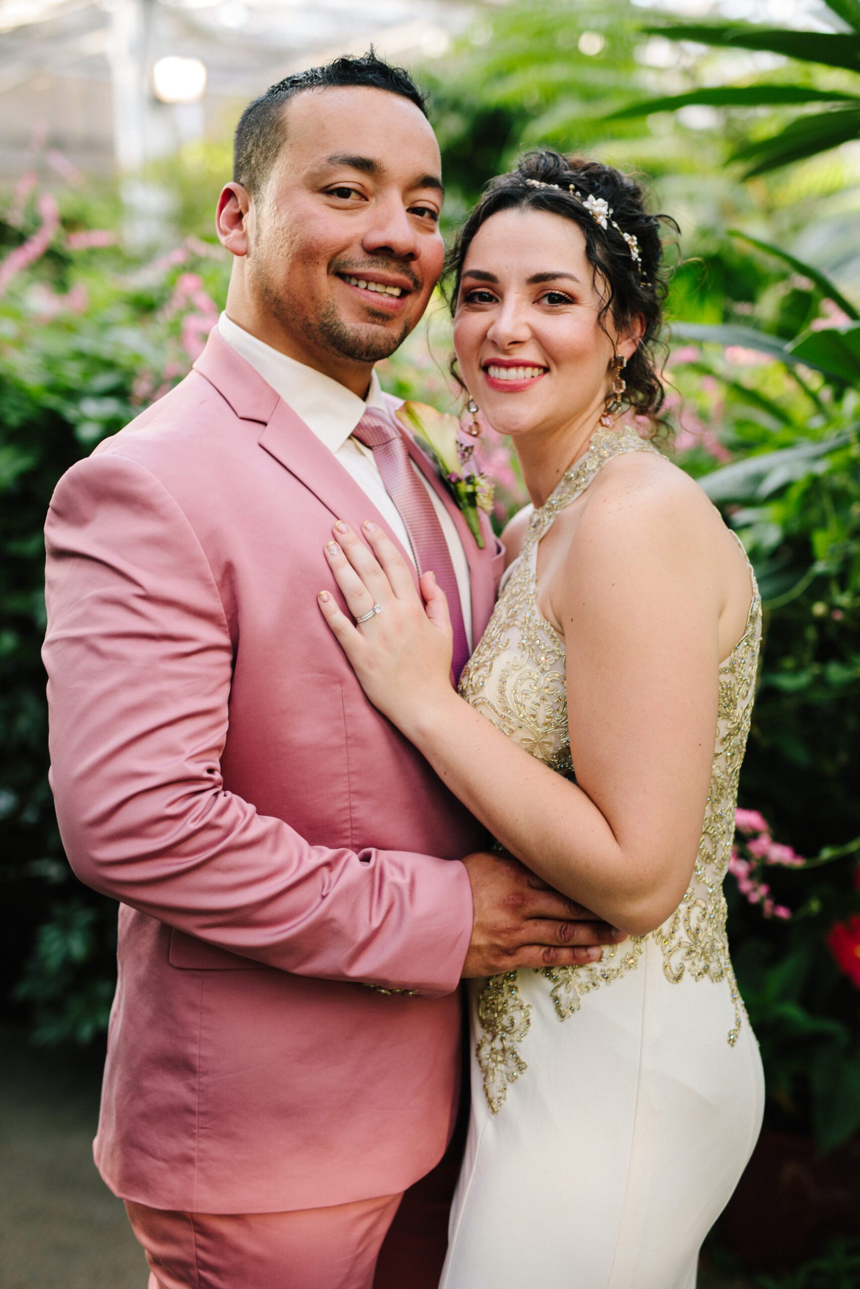 The bride and groom smiling together and looking at the camera after their Butterfly Pavilion Wedding. ⁠