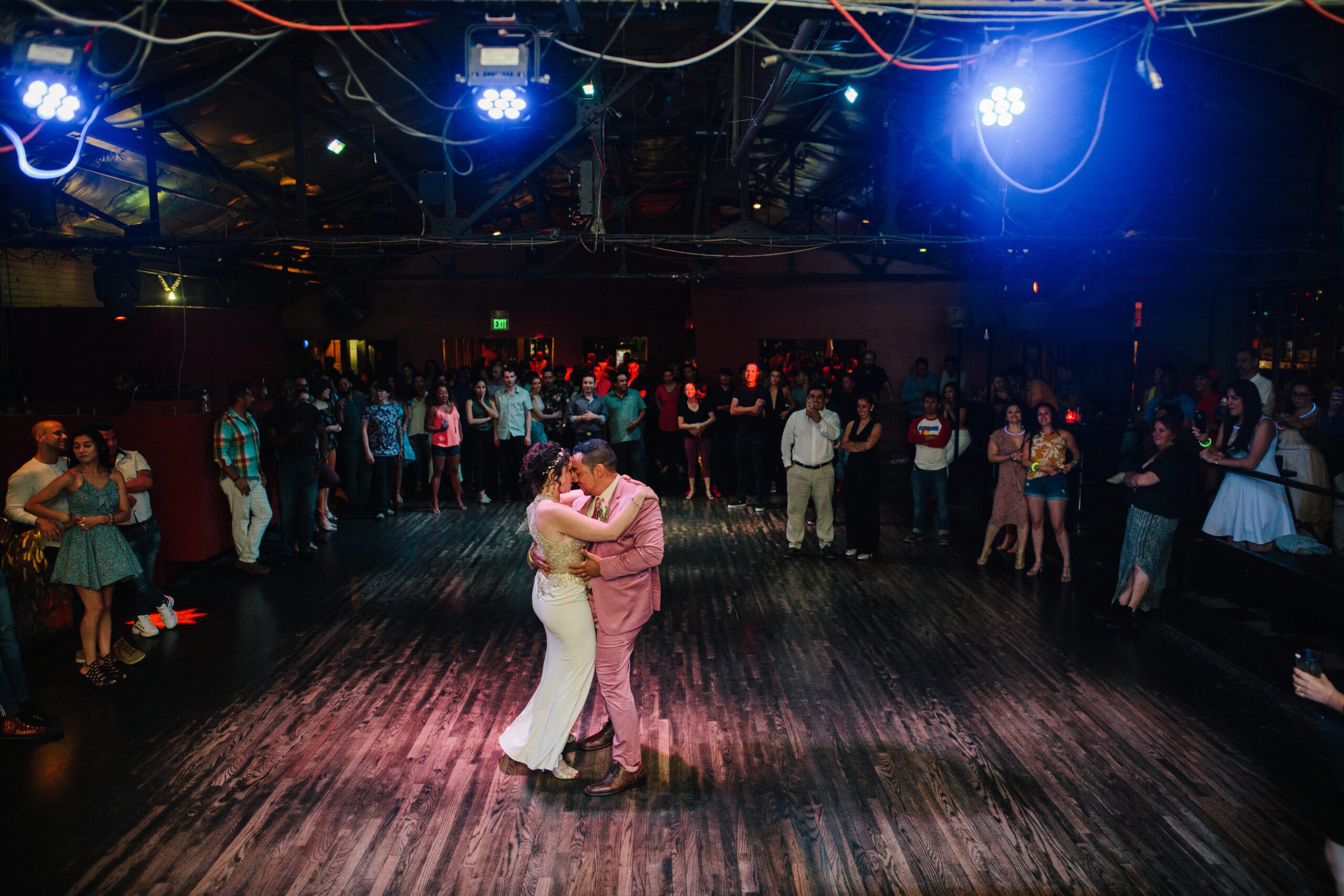 The bride and groom in the center of the dance floor, dancing to their first song as husband and wife at La Rumba. 