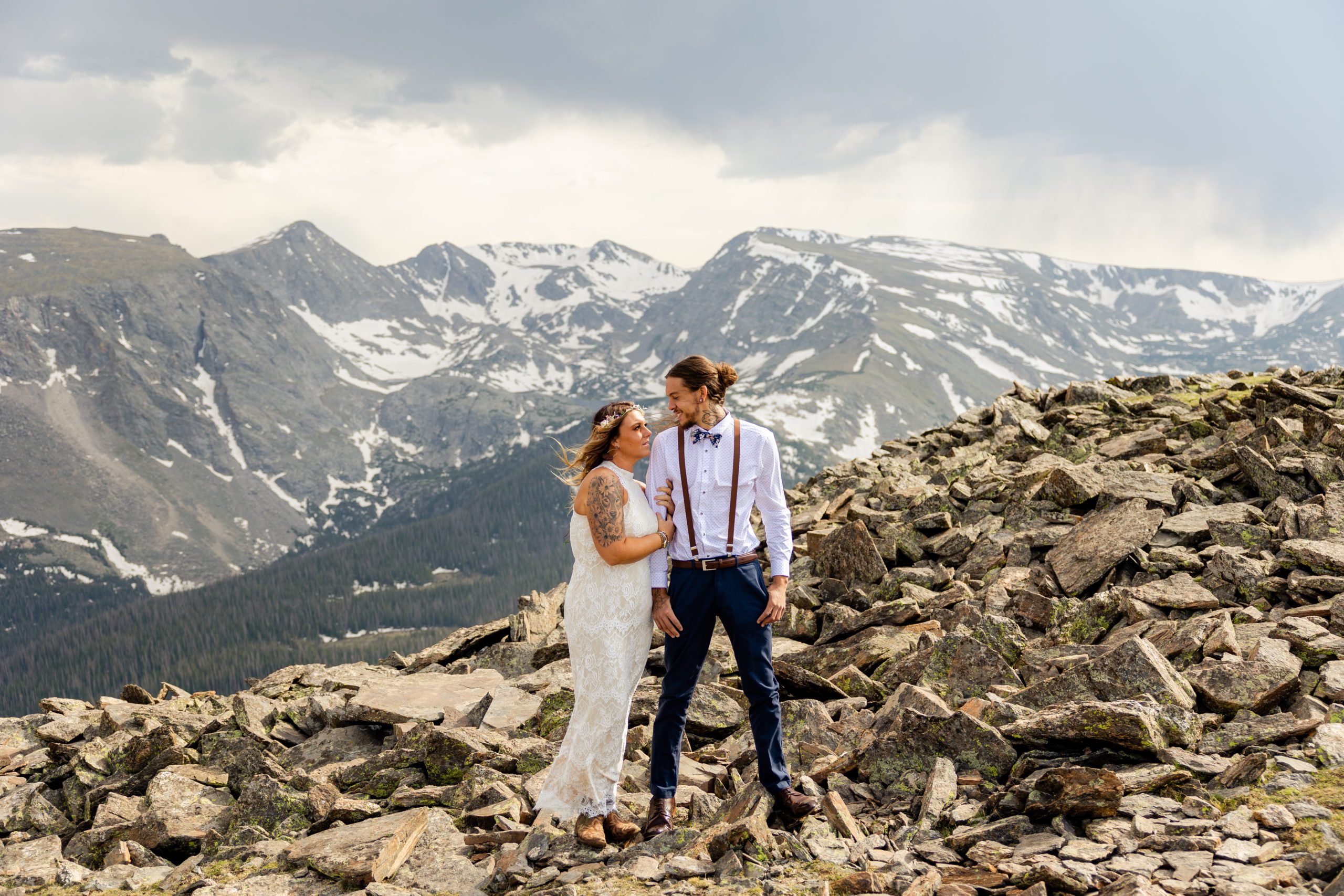Bride and groom hiking on Trail Ridge Road in Rocky Mountain National Park Colorado before their elopement ceremony at Sprague Lake