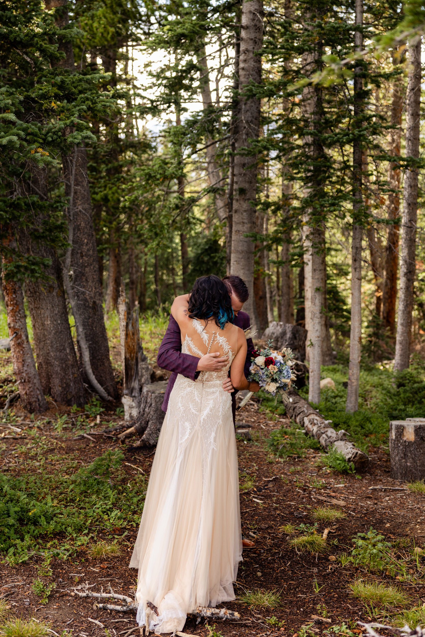 Groom hugging his bride during their first look before their Brainard Lake Elopement ceremony. 