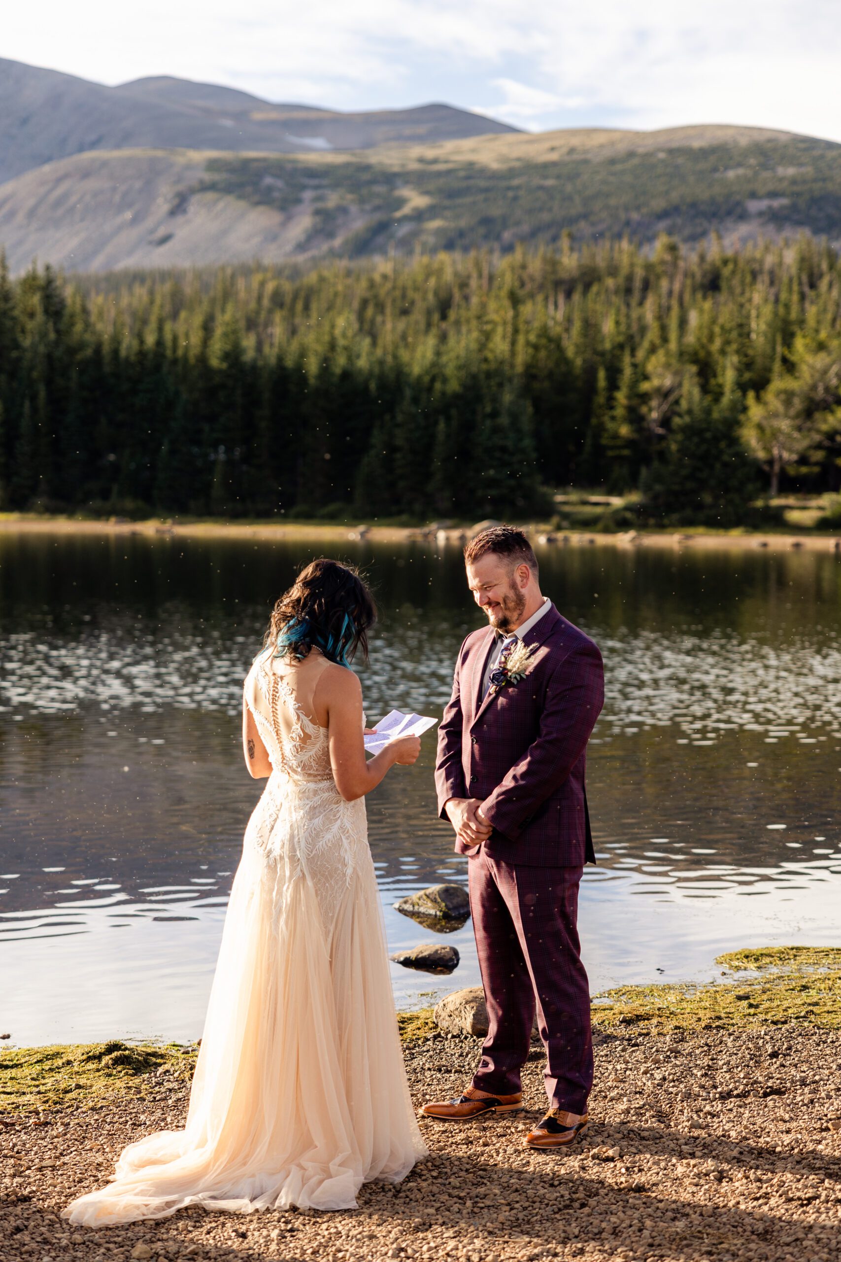 Bride reads her vows to her groom near the lake at their Brainard Lake Elopement. 