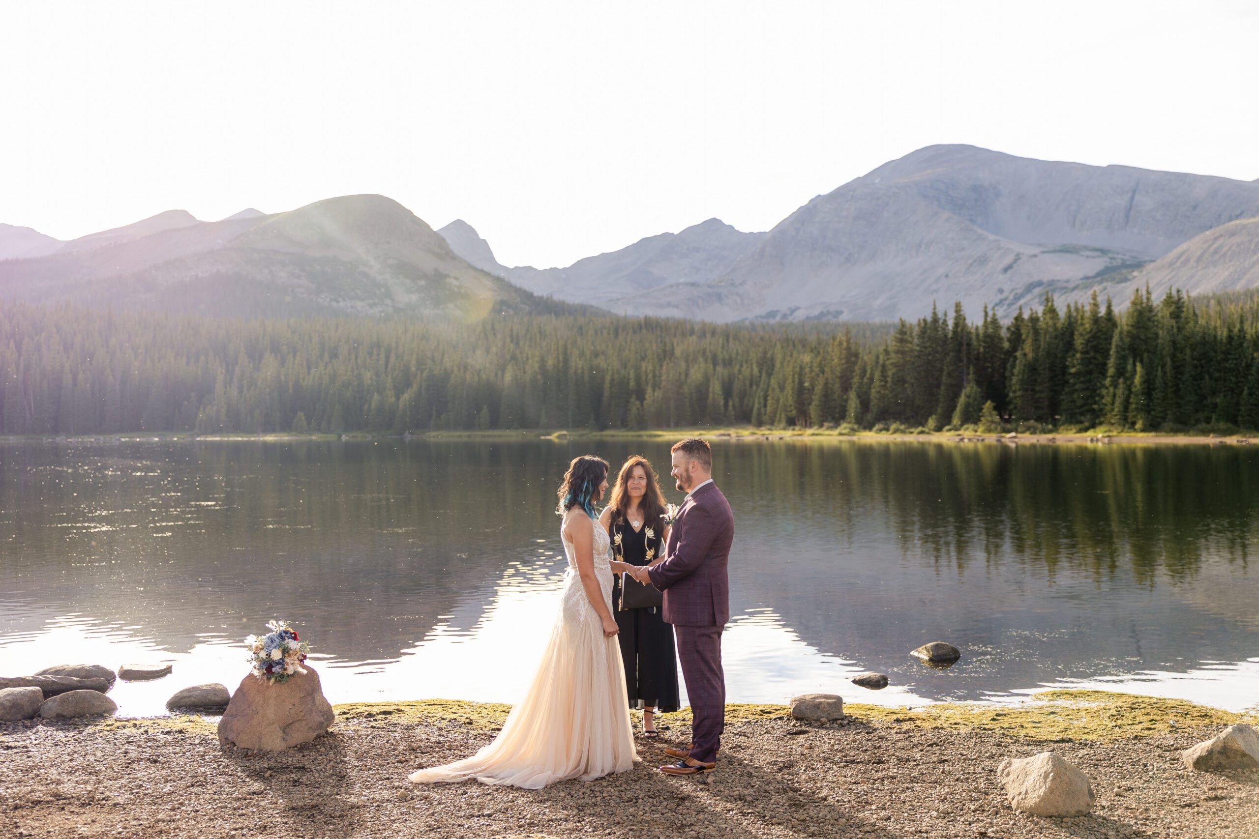 Groom placing the ring on his bride's finger at their Brainard Lake Elopement.