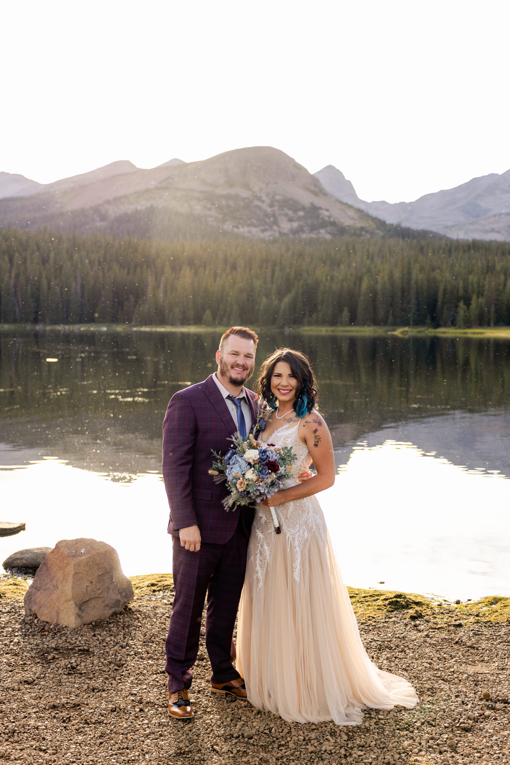 Bride and groom smiling sweetly near the lake at their Brainard Lake Elopement.