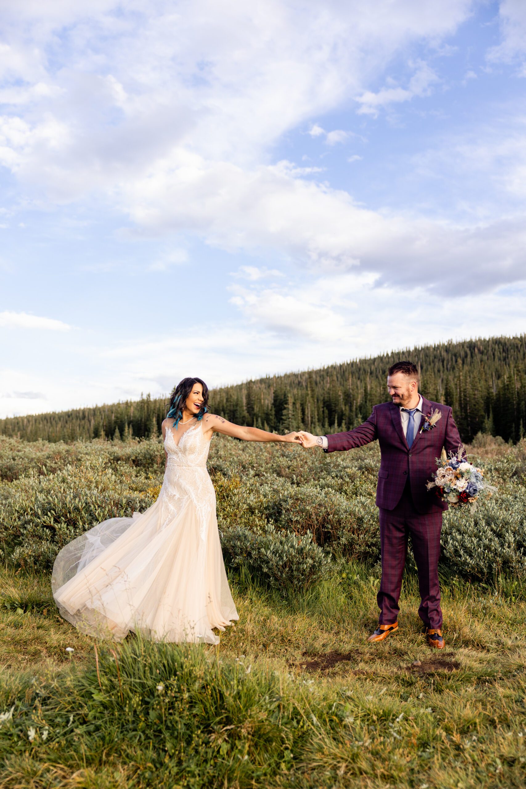 The bride and groom dancing in the meadow after theri Brainard Lake Elopement.