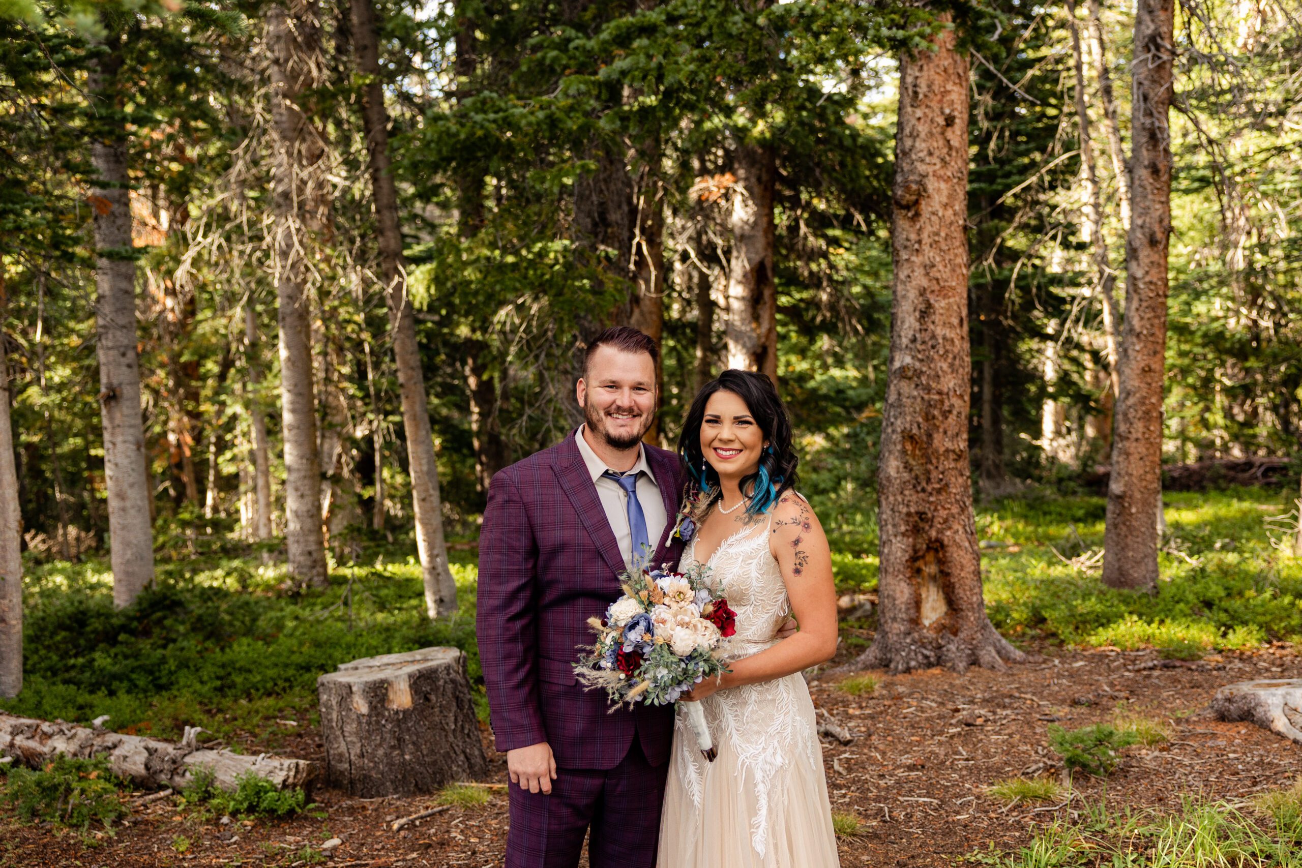 The bride and groom smiling at the camera, before their Brainard Lake Elopement.