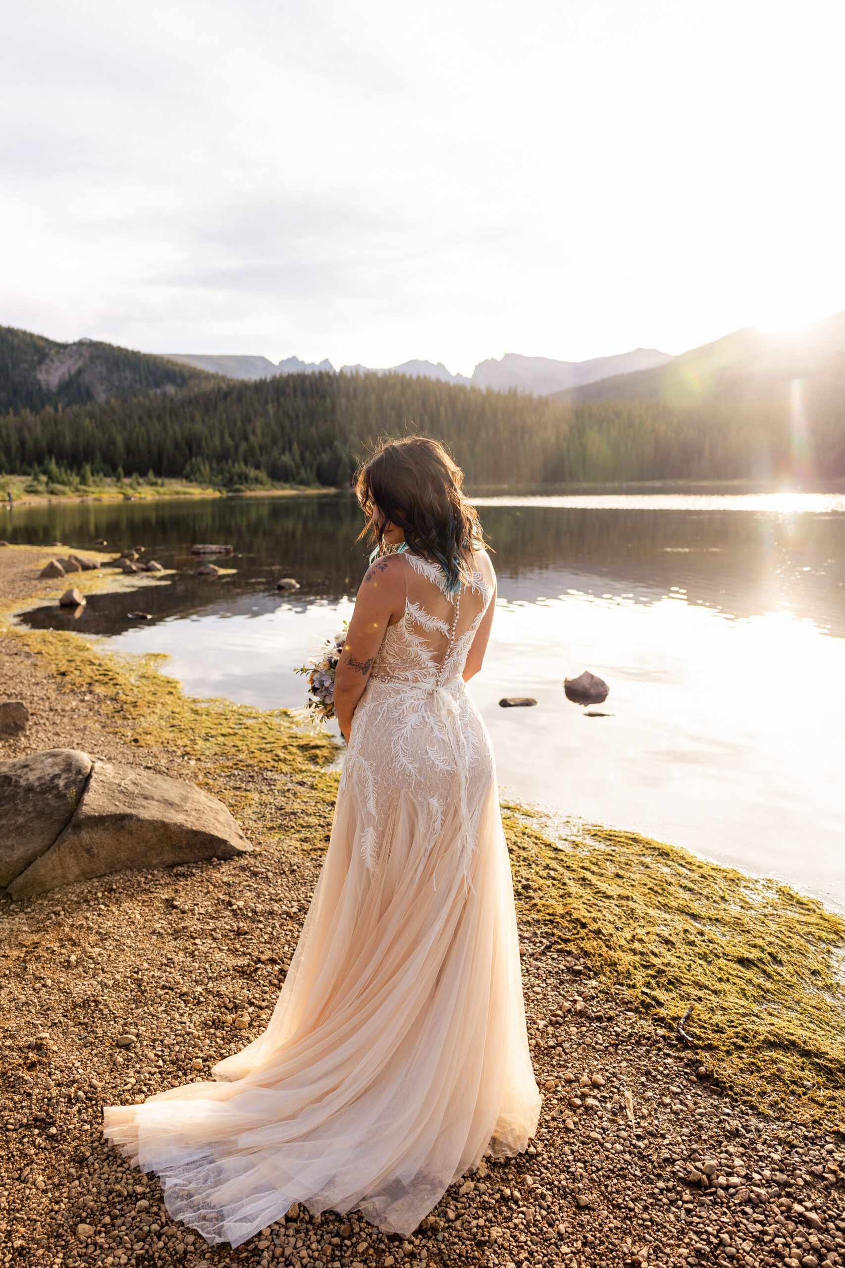 a shot of the bride in her beautiful gown near the lake at her Brainard Lake Elopement.