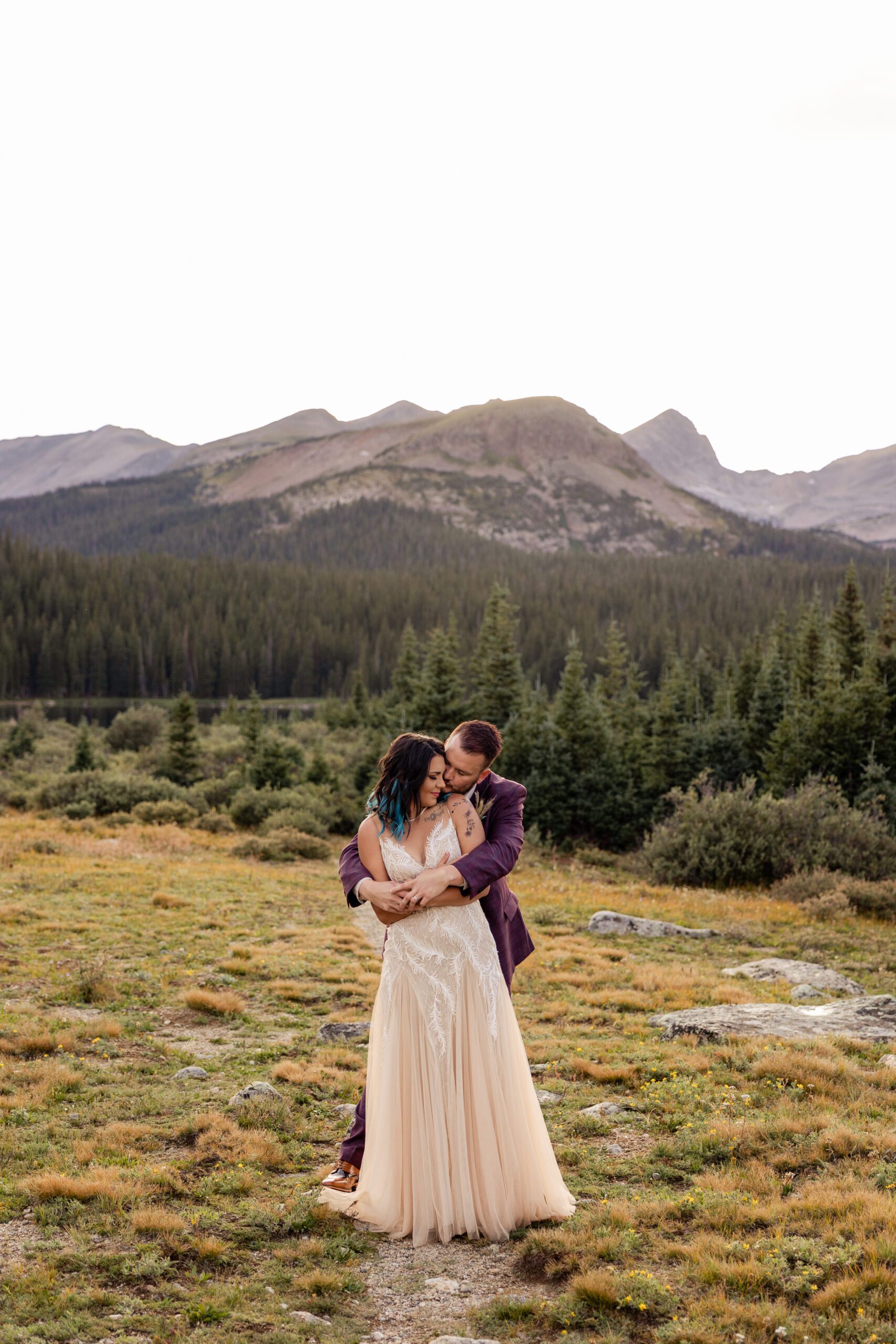 groom wraps his arms around his bride after their Brainard Lake Elopement.