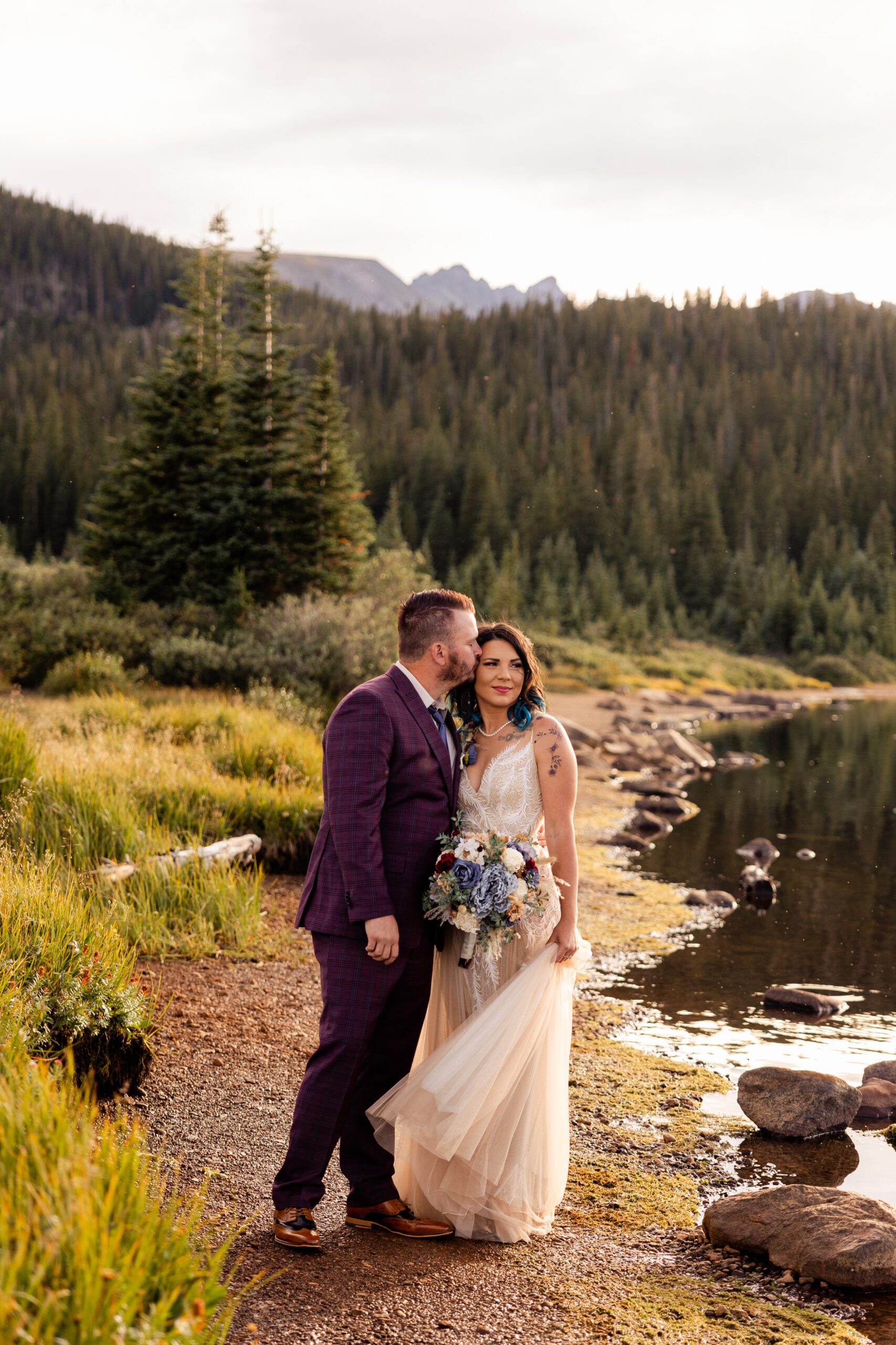 Groom kissing his bride on on the cheek at their Brainard Lake Elopement.