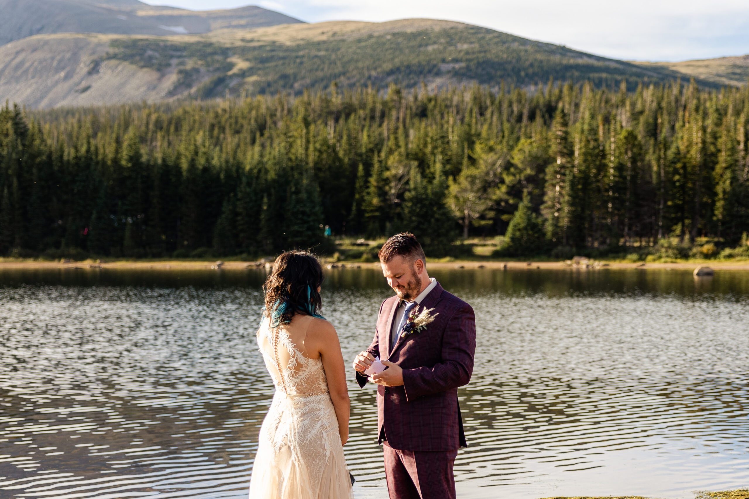 Groom pulls out his vows to read to his bride during their Brainard Lake Elopement.