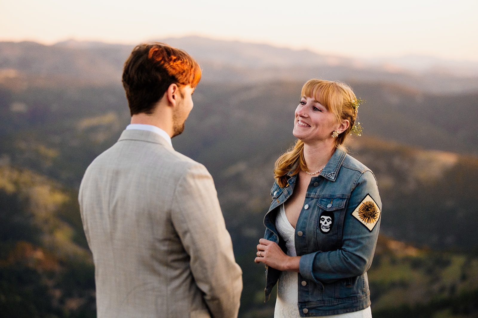 bride reaching for her vows from her jean jacket during sunrise elopement ceremony at Lost Gulch Overlook