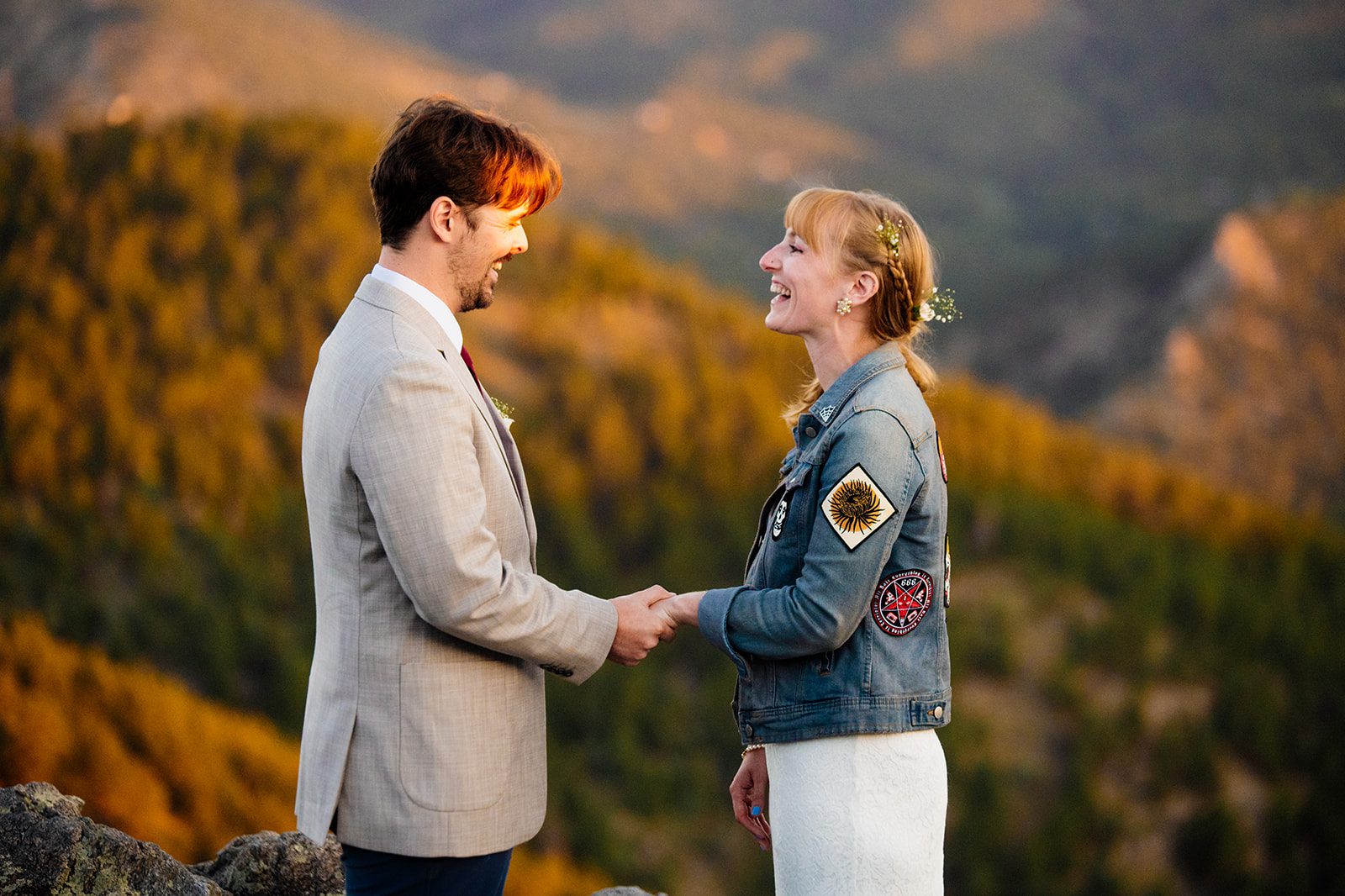 bride and groom holding hands, at sunrise during their intimate elopement ceremony in boulder at Lost Gulch Overlook