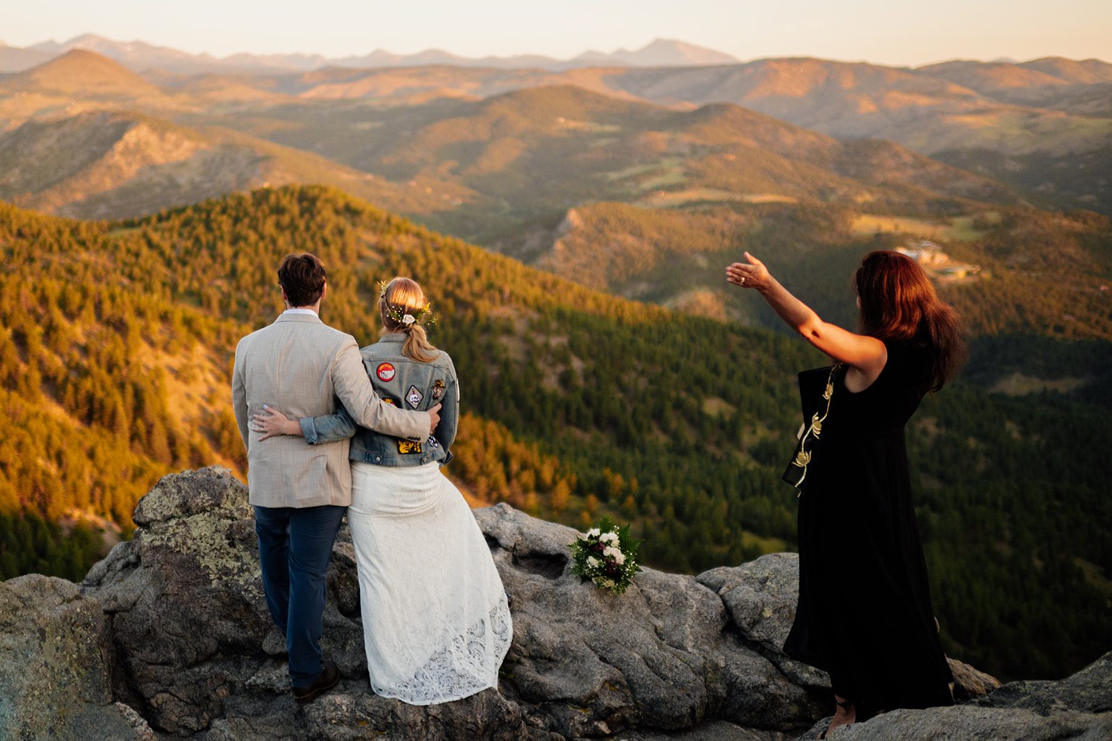 officate celebrates with the newlyweds after their Lost Gulch Overlook elopement ceremony 