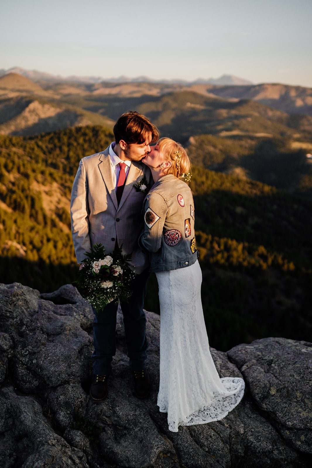 bride and groom kissing atop flagstaff mountain at Lost Gulch Overlook after their elopement 