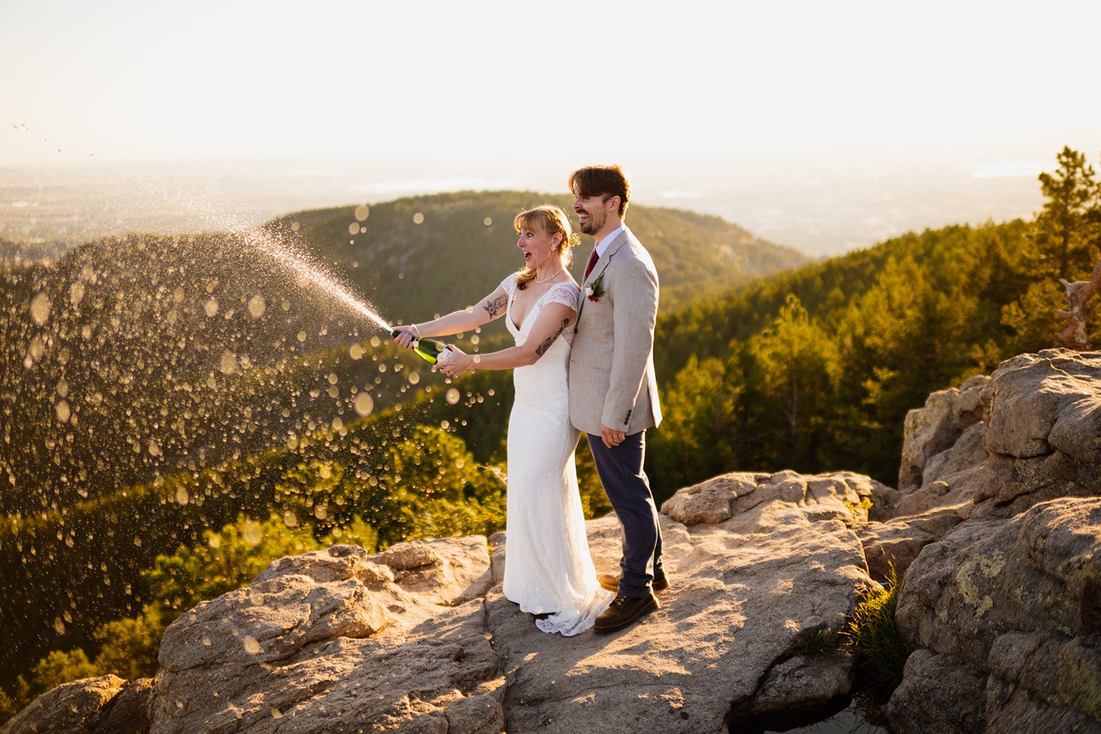 bride and groom celebrate with champagne after their Lost Gulch Overlook elopement at sunrise. 