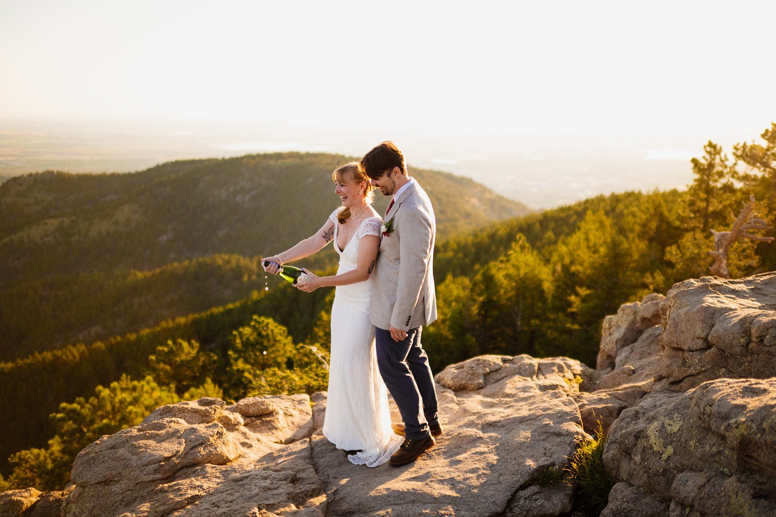 bride and groom laughing during sunrise elopement at Lost Gulch Overlook.