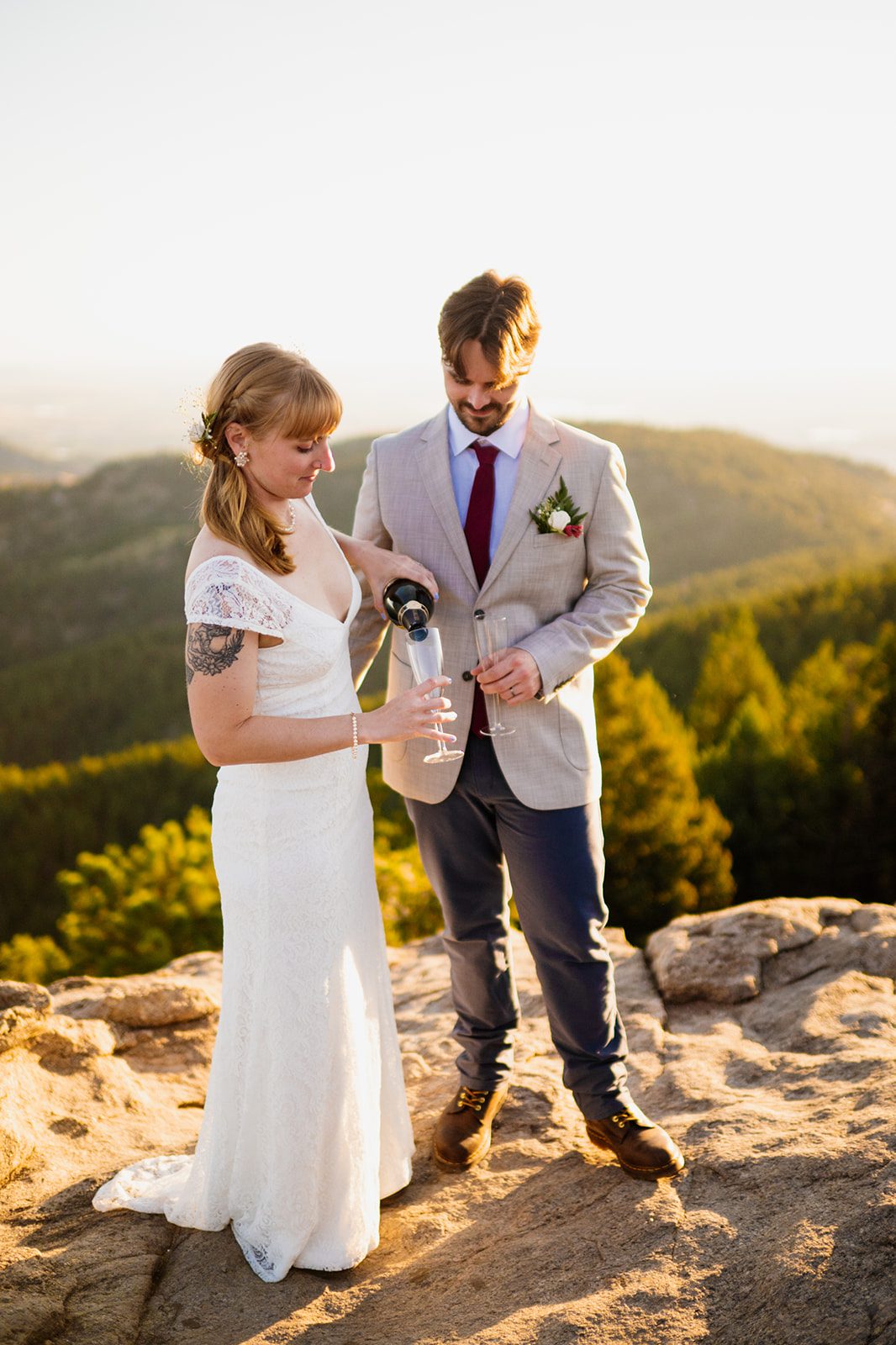 bride and groom pouring champagne to celebrate at Lost Gulch Overlook