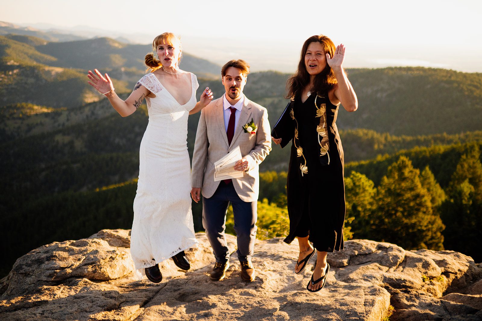 a celebratory jump with officiant after Lost Gulch Overlook sunrise elopement. 