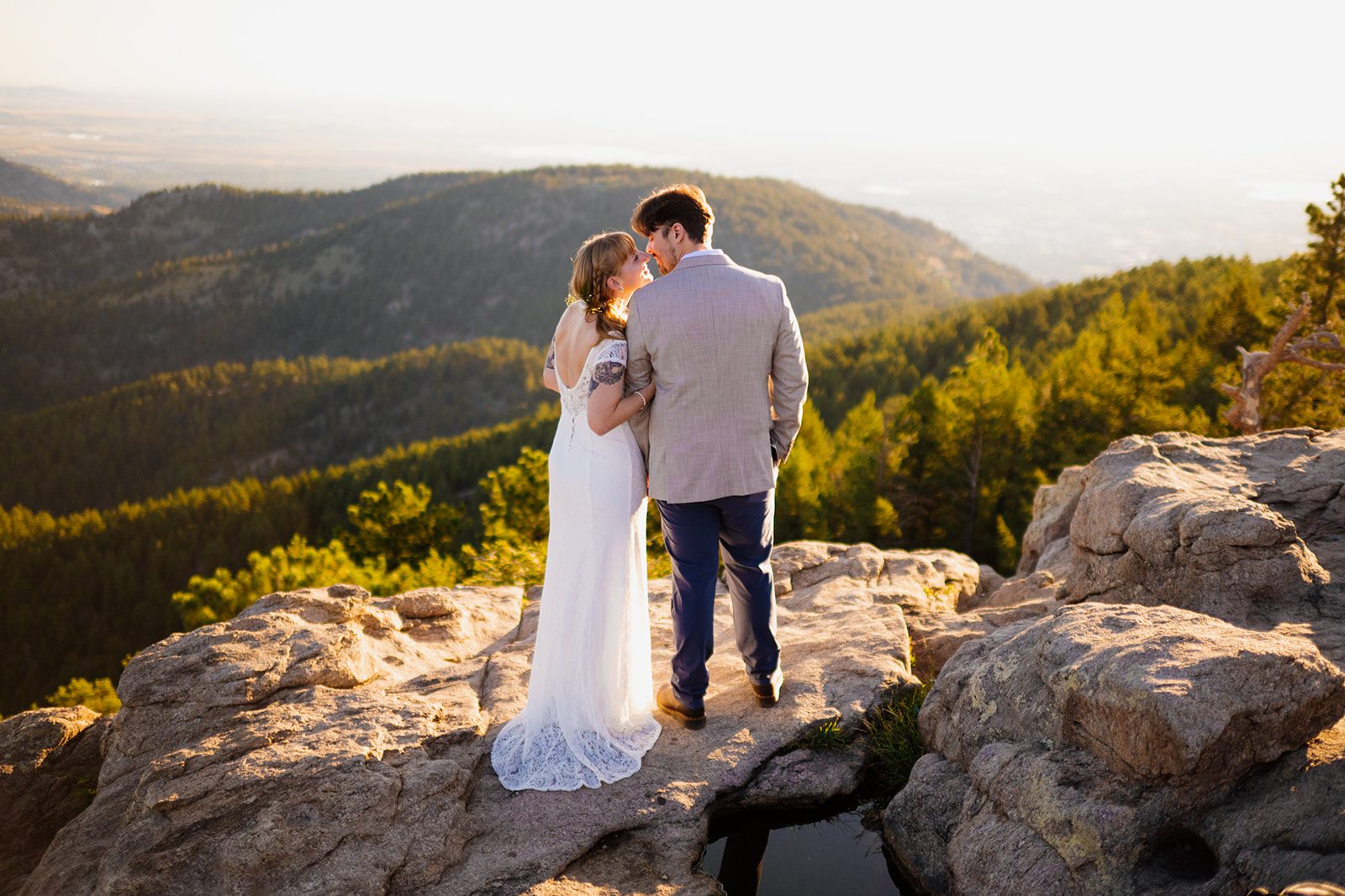 bride and groom kiss, bride in white wedding dress at sunrise during their Lost Gulch Overlook elopement 