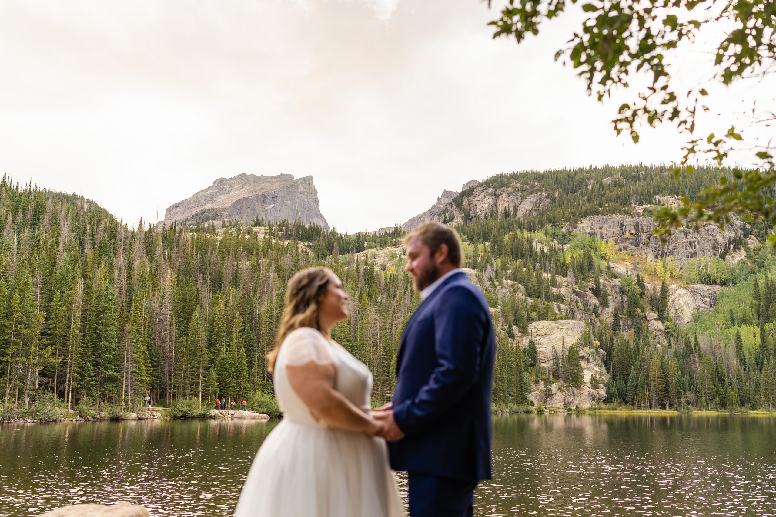 bride and groom holding hands looking at each other during their Bear Lake elopement. 