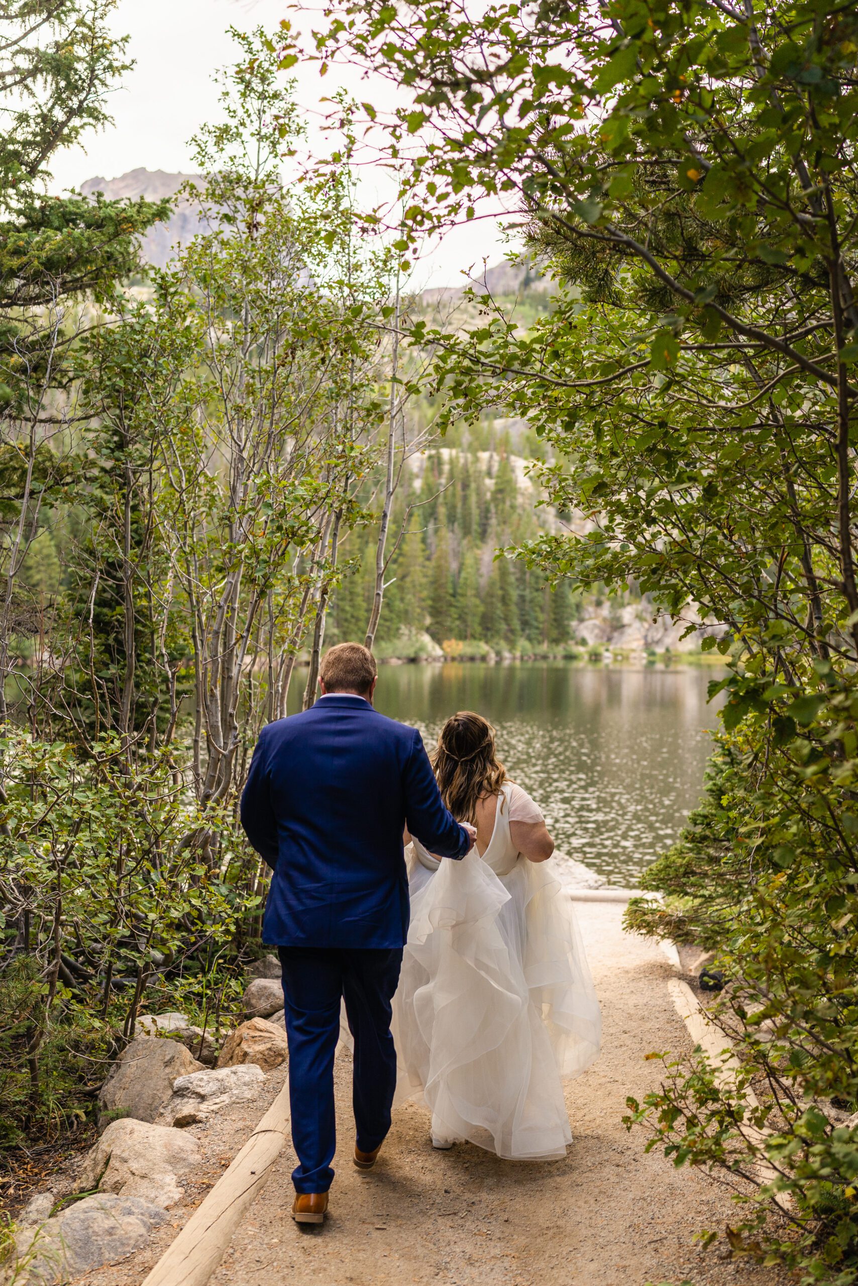 the bride and groom walking to the lake during their Bear Lake elopement. 