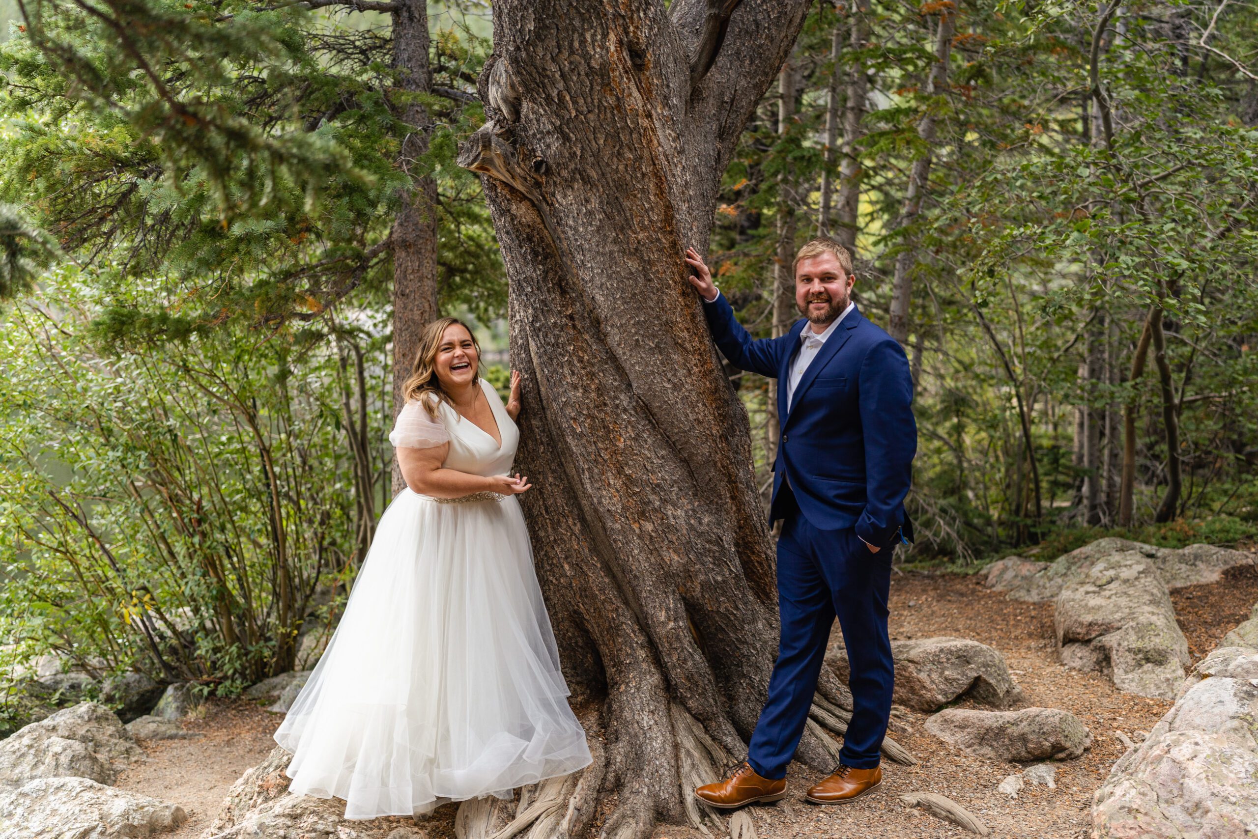the bride and groom standing by a tree their Bear Lake elopement. 