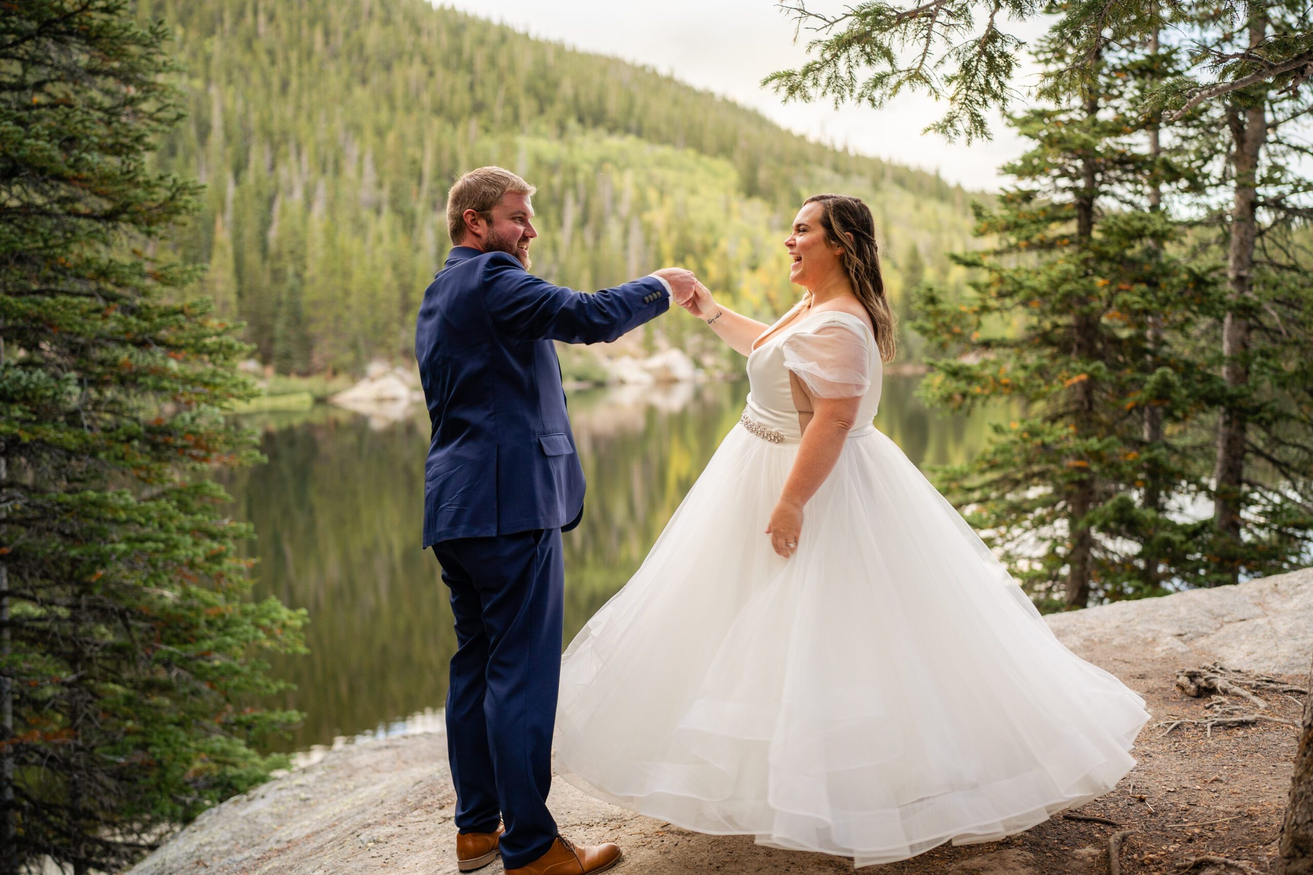 the groom twirls his bride during their Bear Lake elopement. 