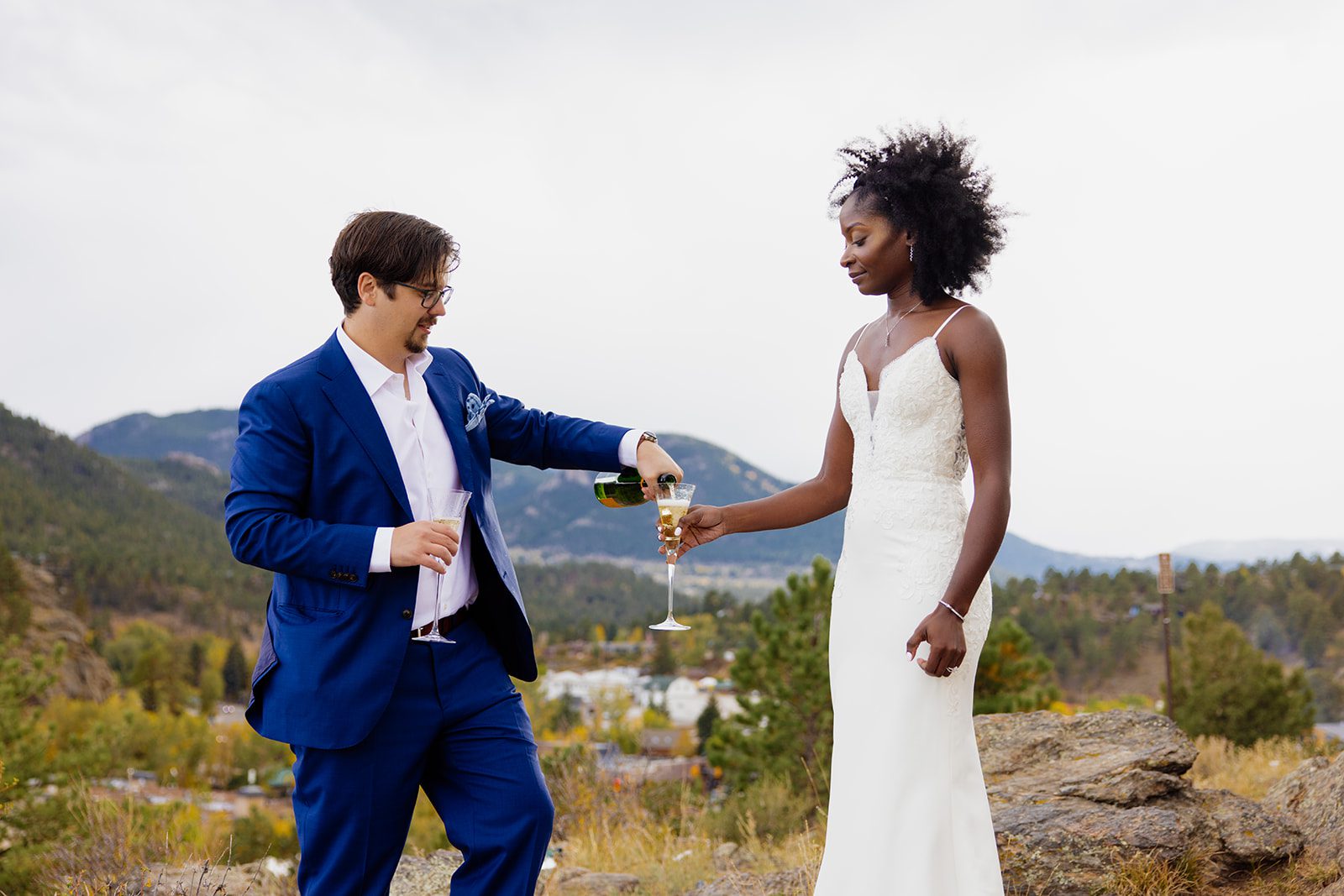 groom pouring his bride champagne after their Knoll Willows Elopement ceremony. 
