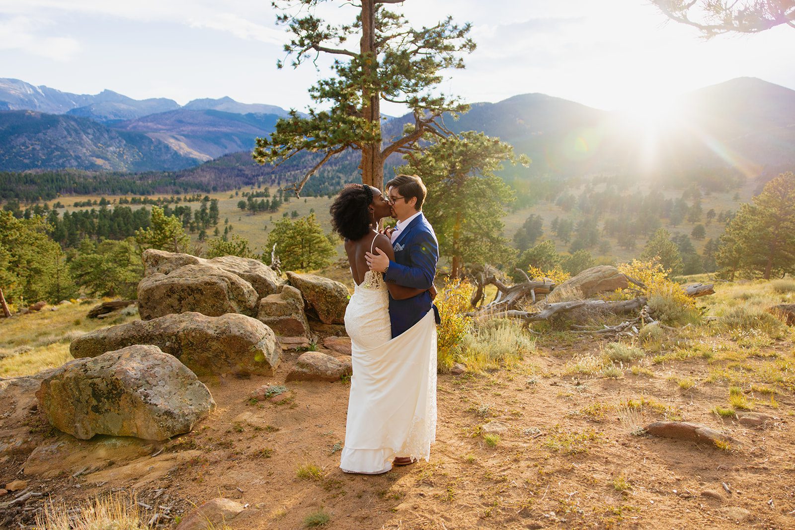 Sunset at Rocky Mountain National Park, bride and groom kissing. 