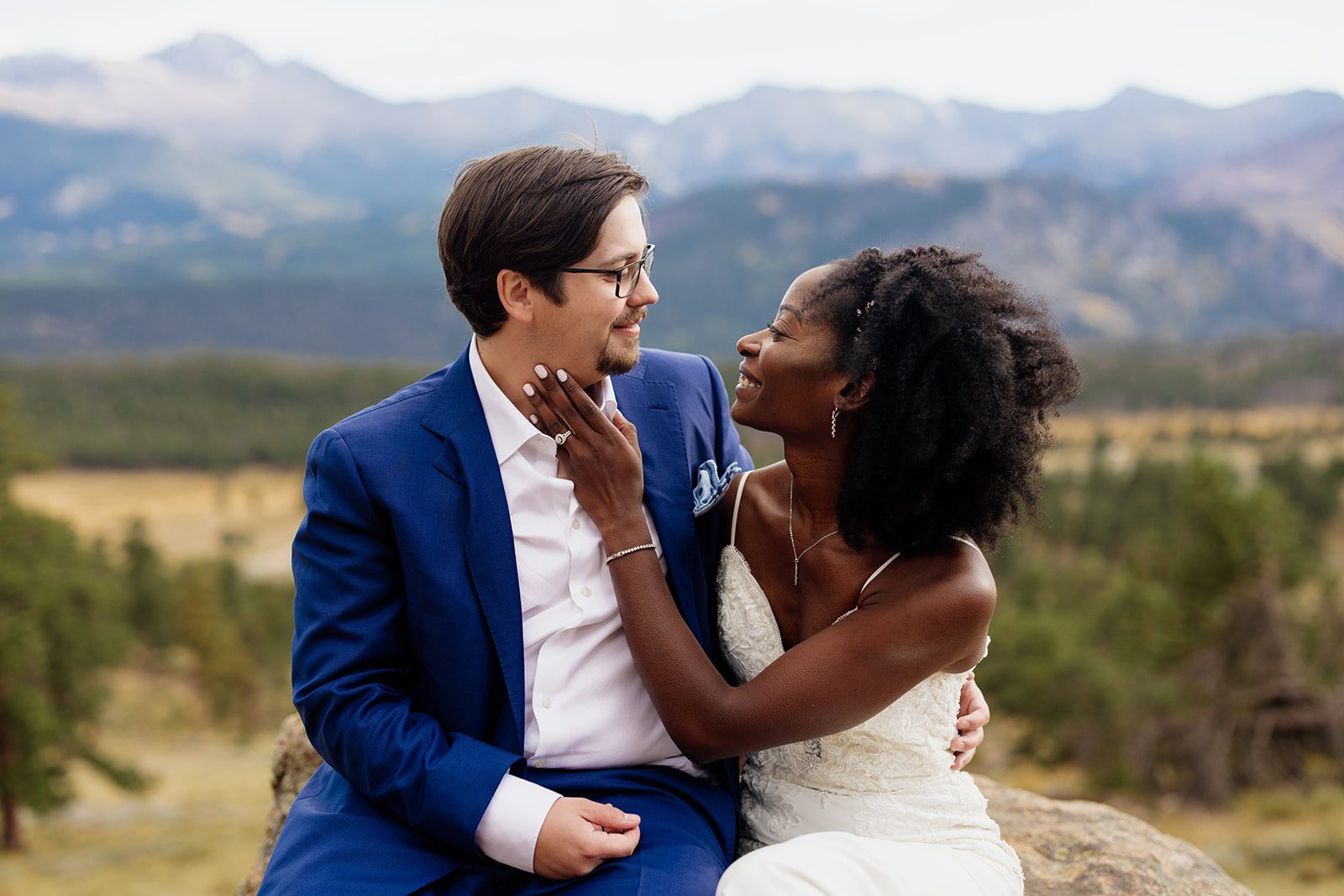 close up of bride and groom in navy blue suit at sunset in rocky mountain national park after their Knoll Willows Elopement.
