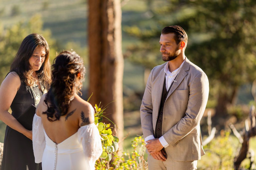 Groom looks lovingly at his bride during elopement ceremony 