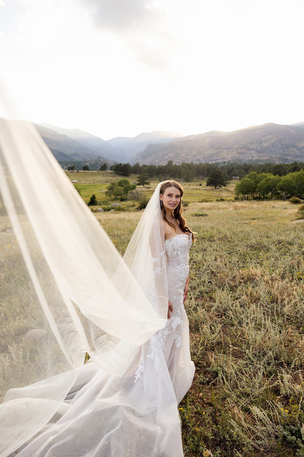 The beautiful bride with her veil blowing in the wind. 