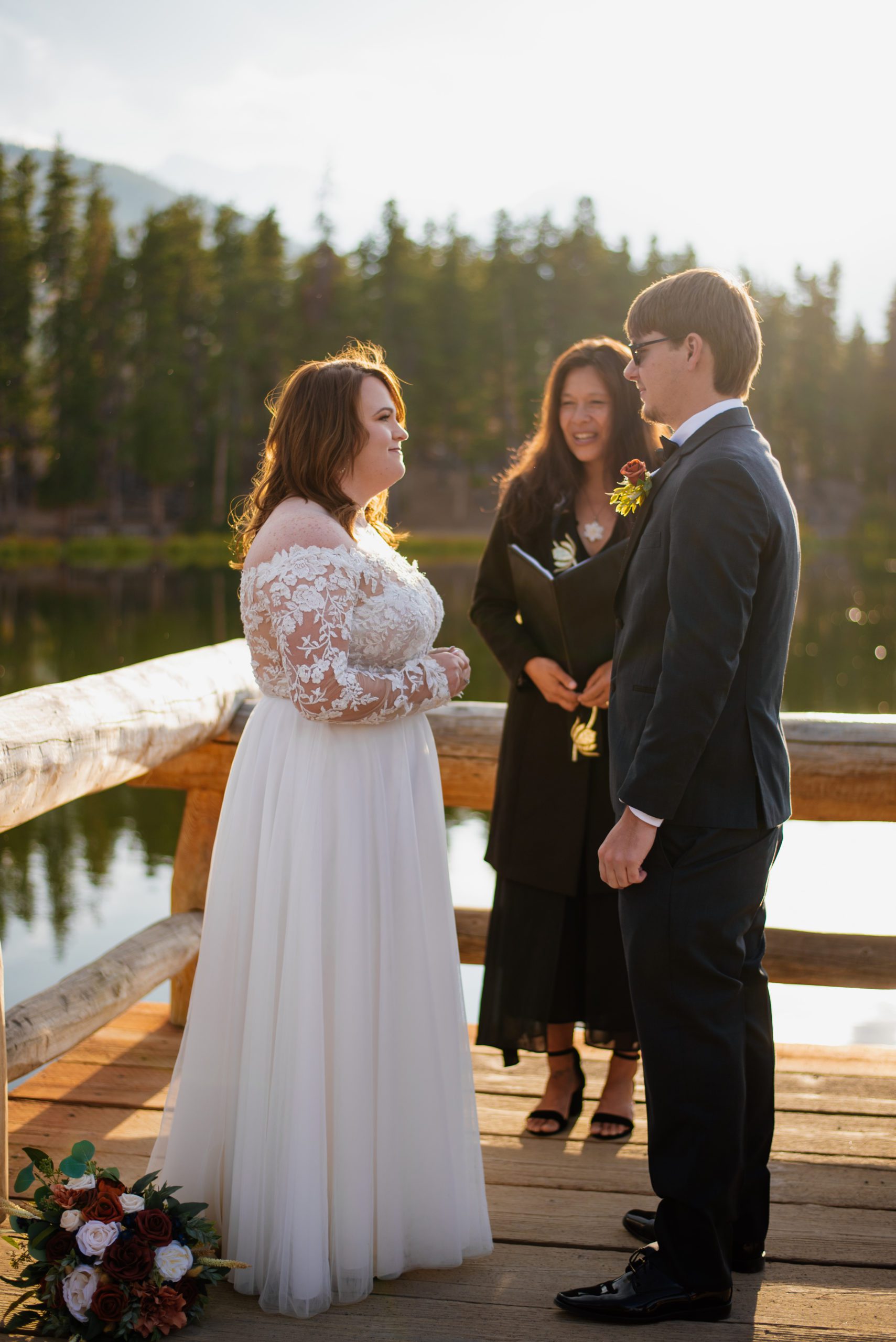 Bride Smiles at groom during elopement ceremony at Sprague Lake - RMNP