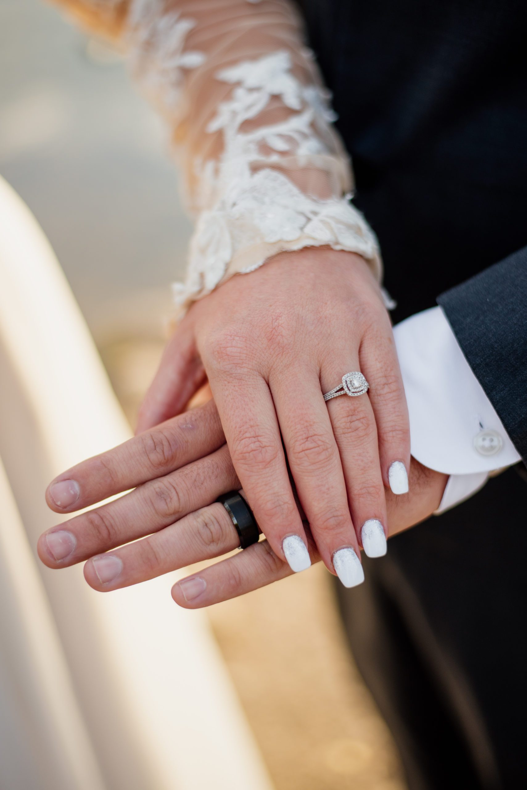 BRide and groom's hands, with the bride's ring at Sprague Lake - RMNP
