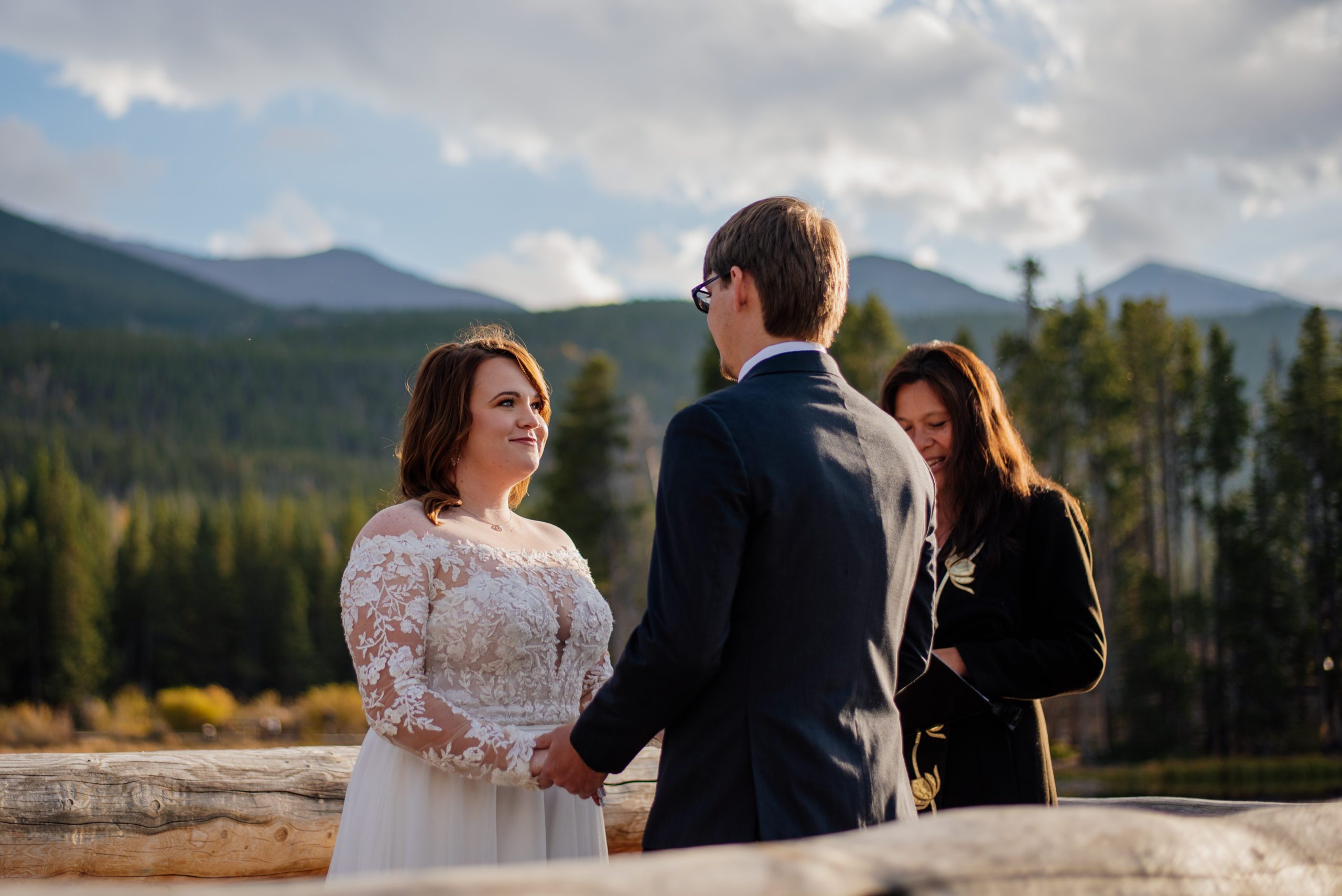 Bride looks at her groom with a smile during elopement ceremony at Sprague Lake - RMNP