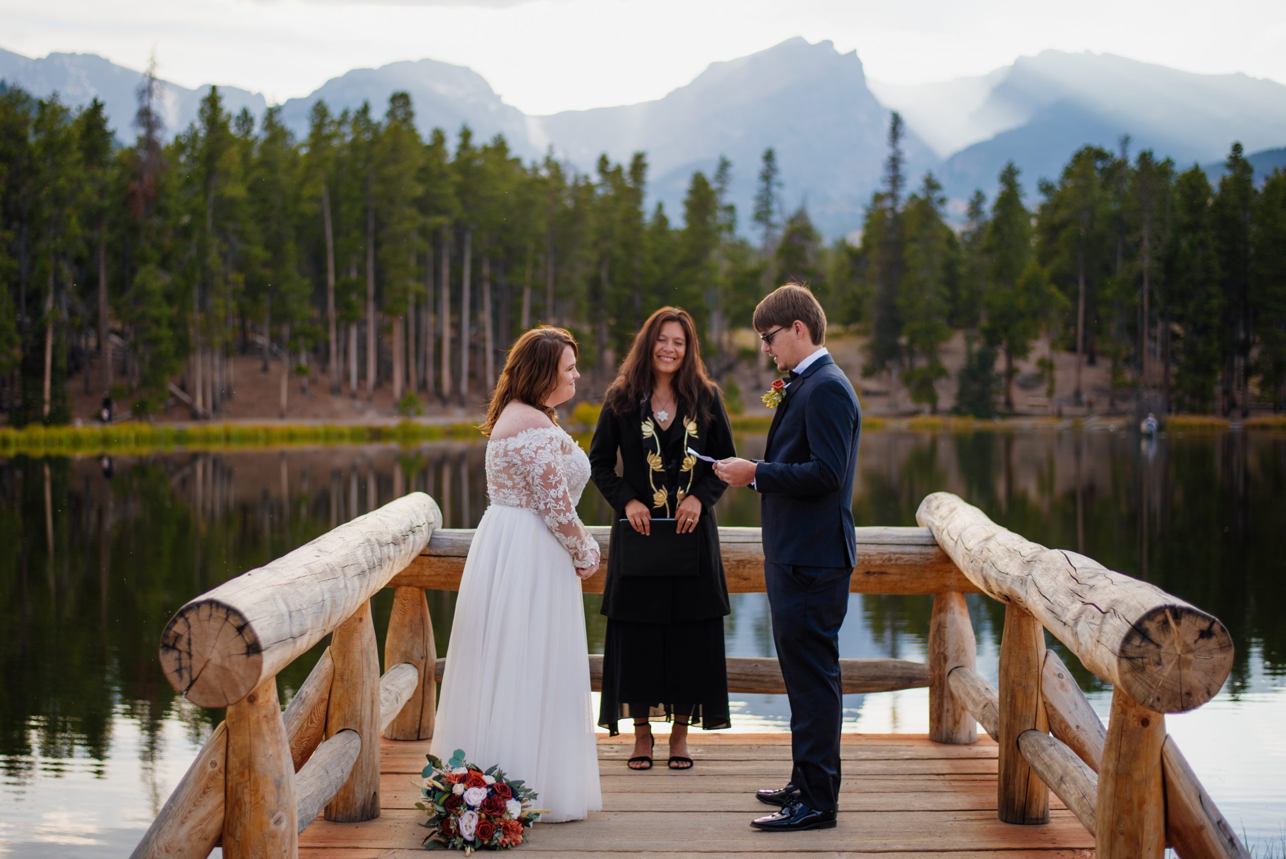 Groom reads vows to his Bride during elopement Ceremony at Sprague Lake - RMNP