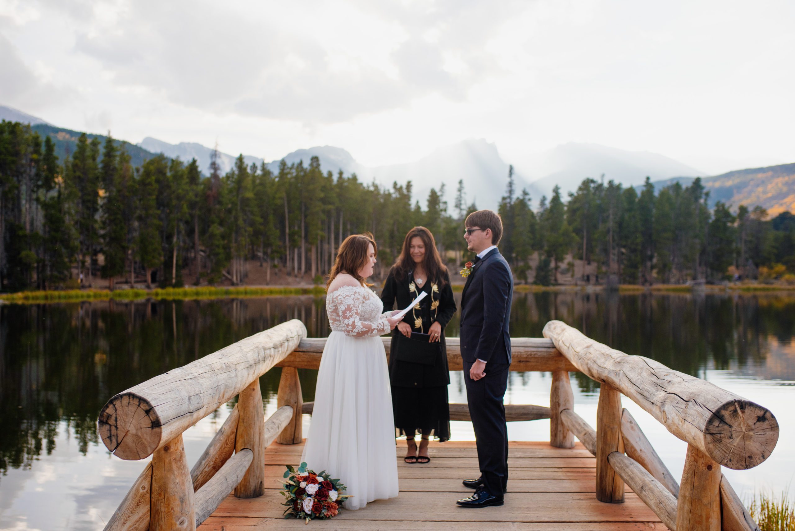 Bride reads vows to groom during elopement ceremony 
at Sprague Lake - RMNP