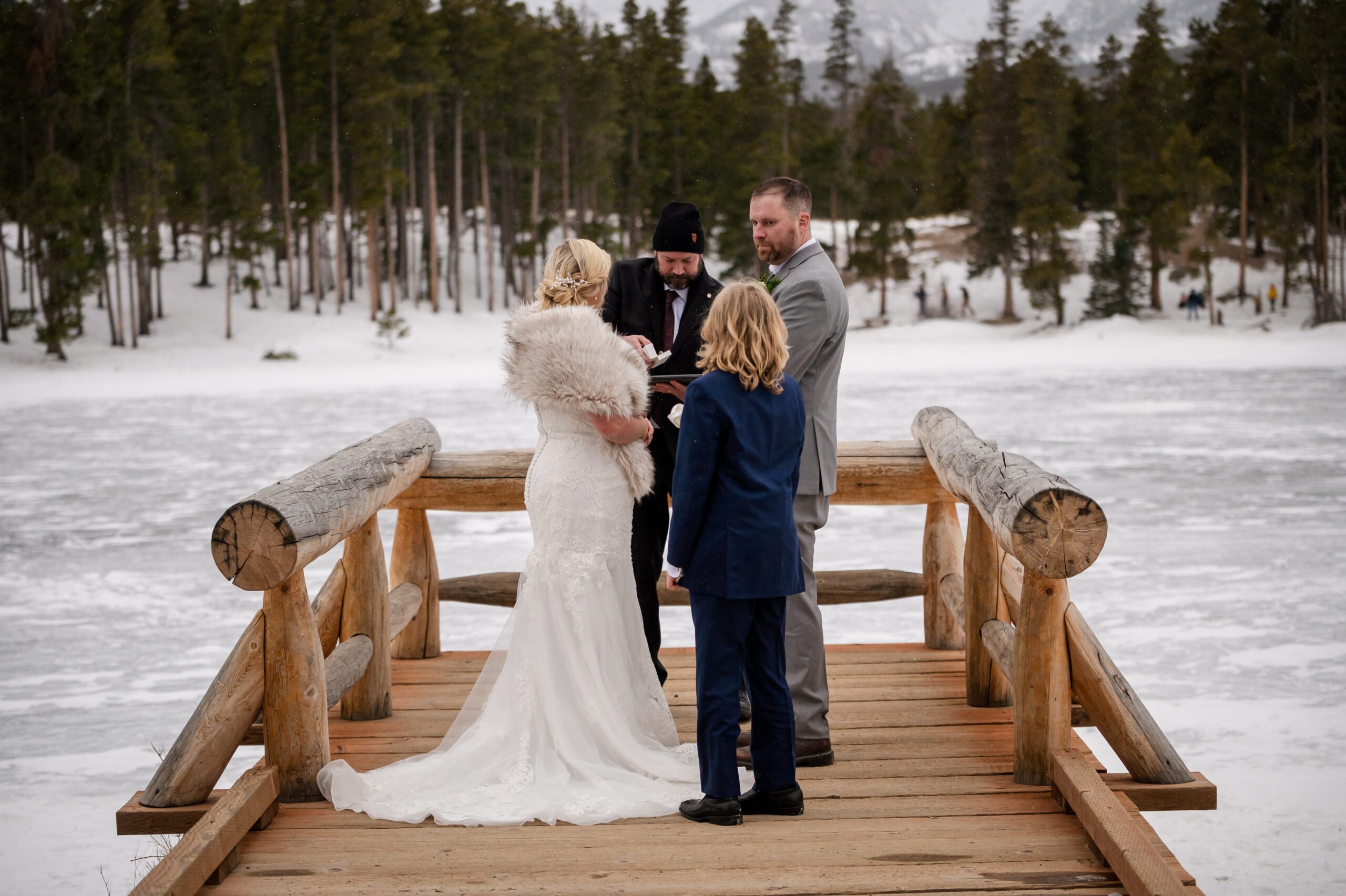 the bride and groom during their ceremony with the bride's son at their Winter Elopement at Sprague Lake. 