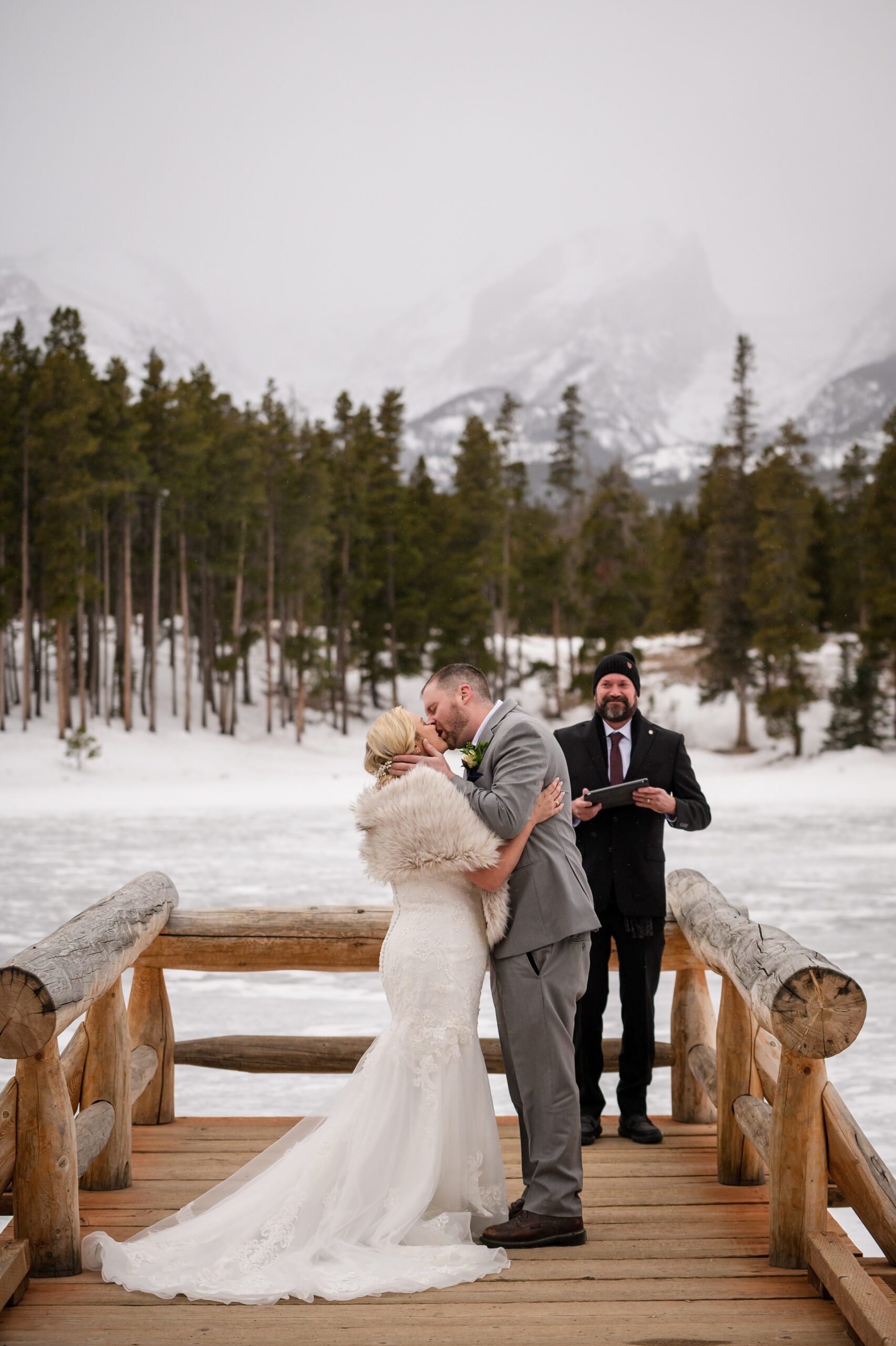 their first kiss as newlyweds, during their Winter Elopement at Sprague Lake. 