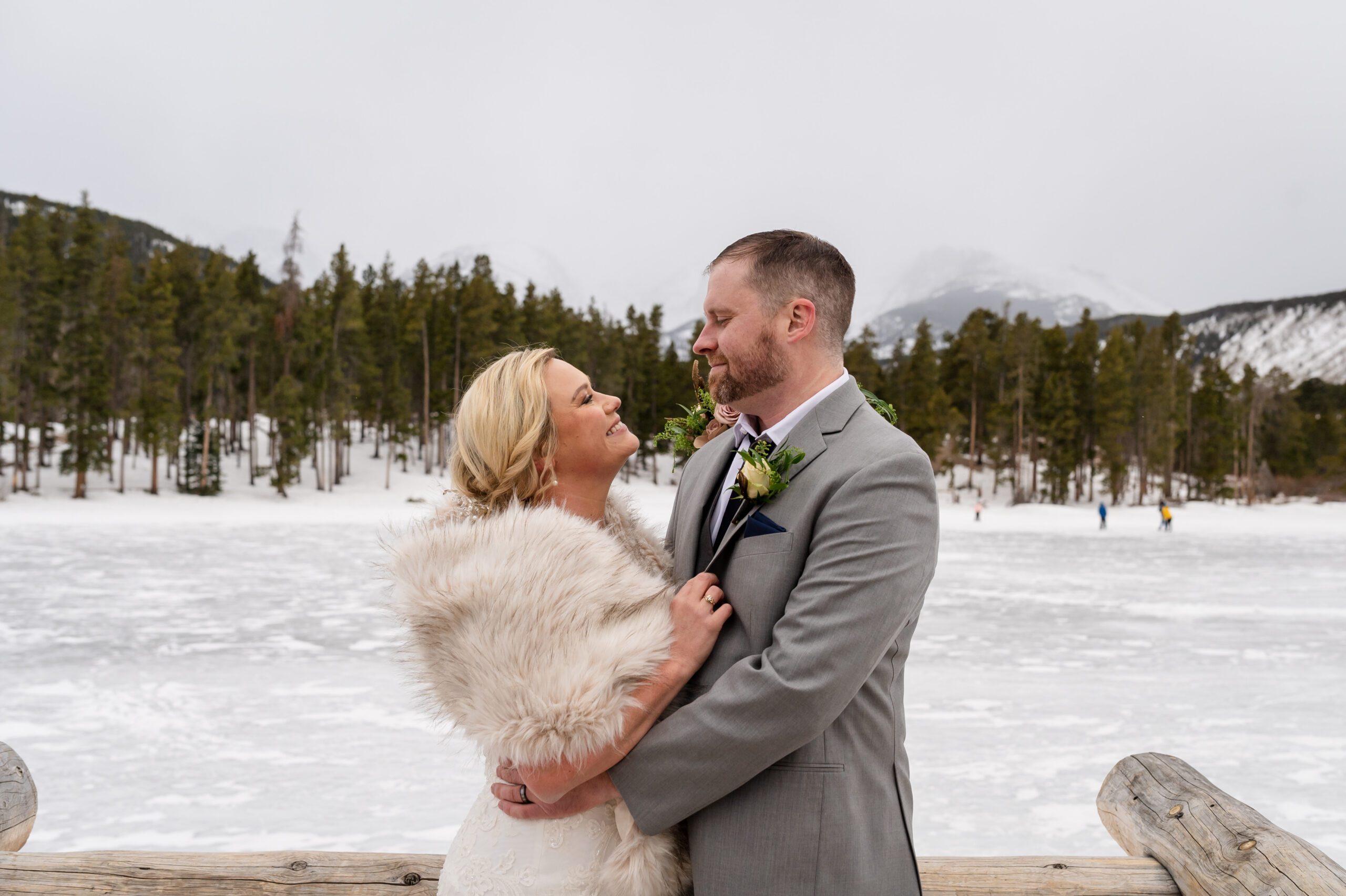 the bride and groom smiling sweetly at each other after their Winter Elopement at Sprague Lake. 