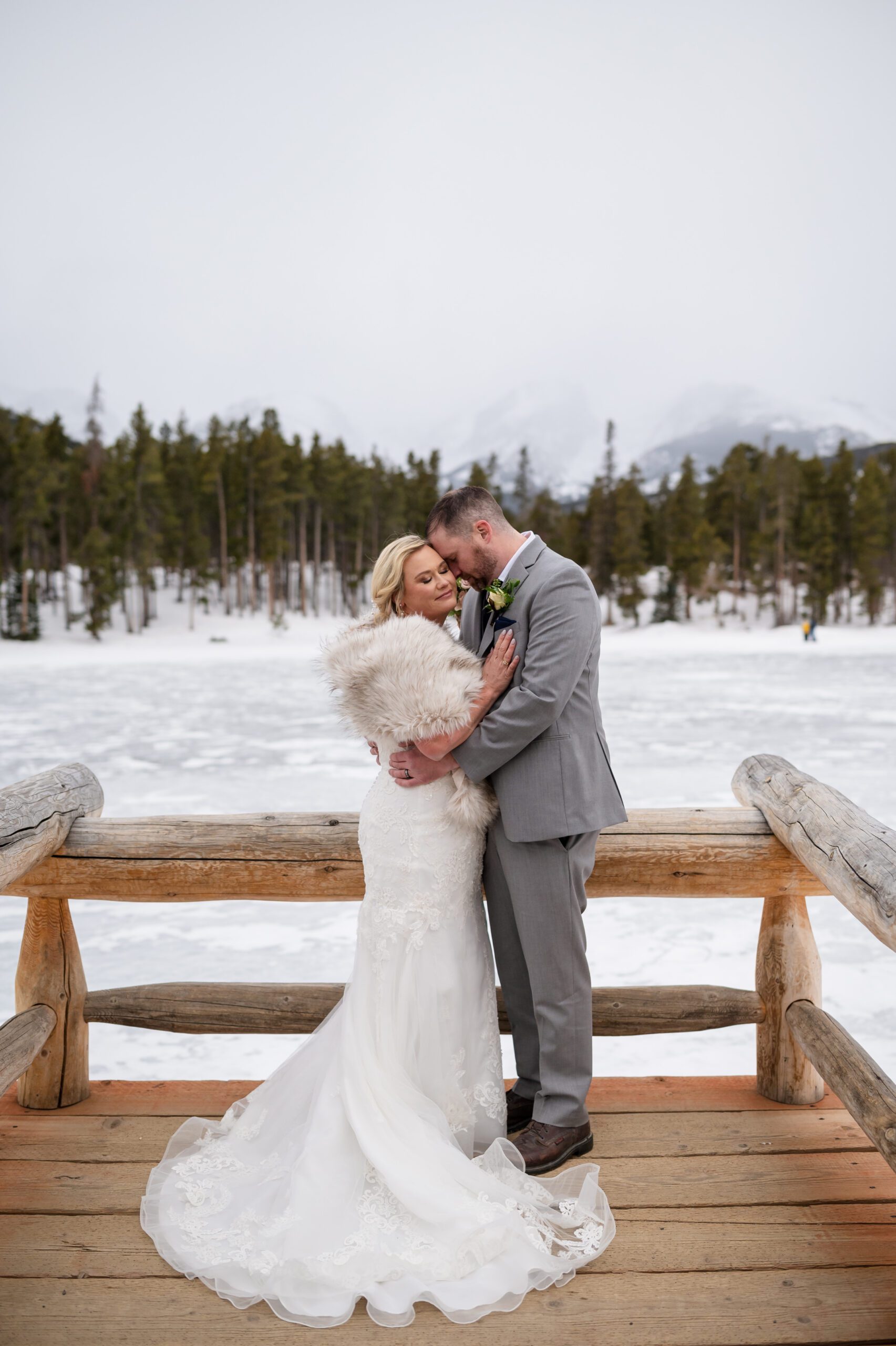 the bride and groom cuddling close after their Winter Elopement at Sprague Lake. 