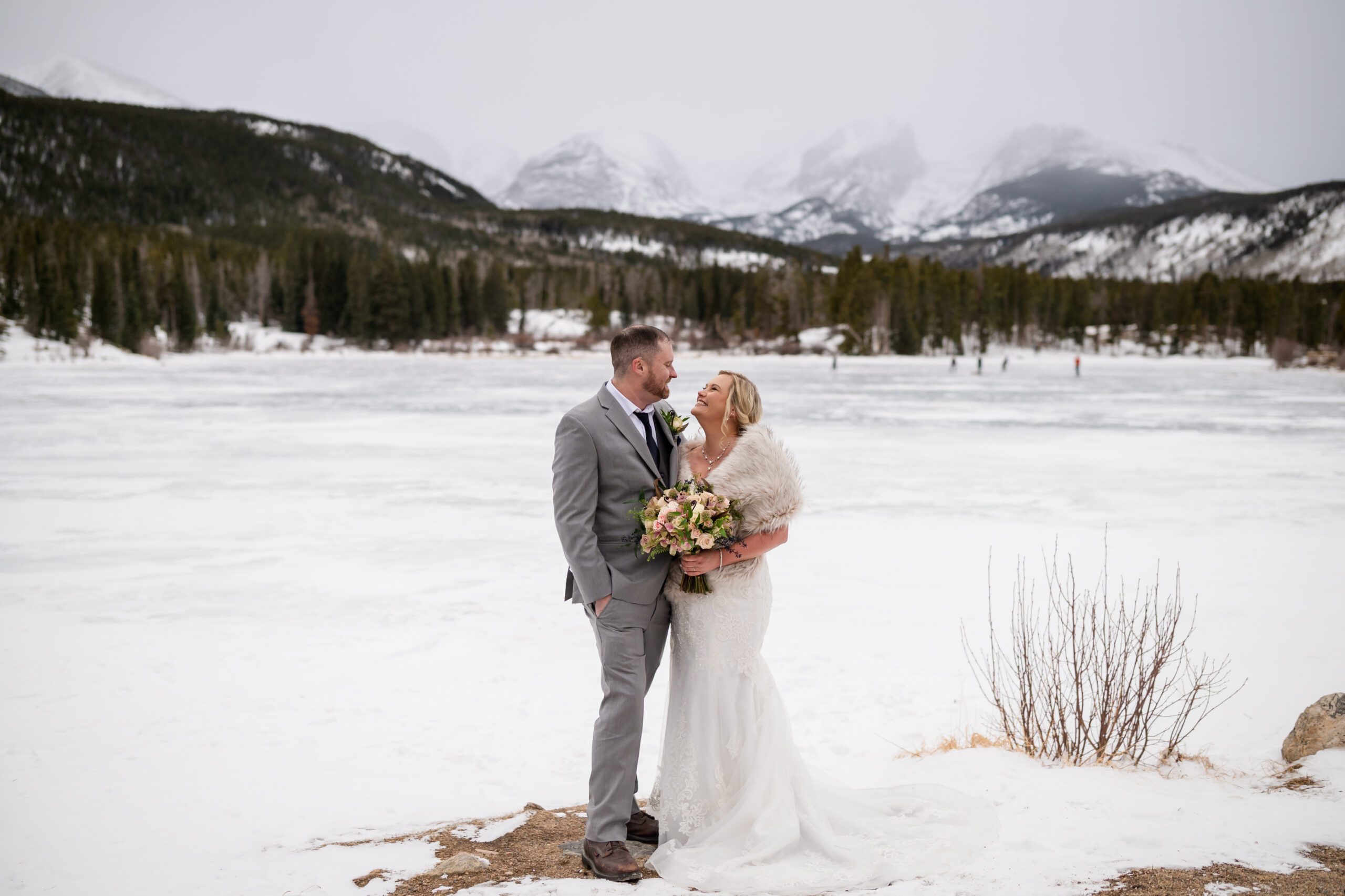 Bride and groom smiling at each other after their Winter Elopement at Sprague Lake.