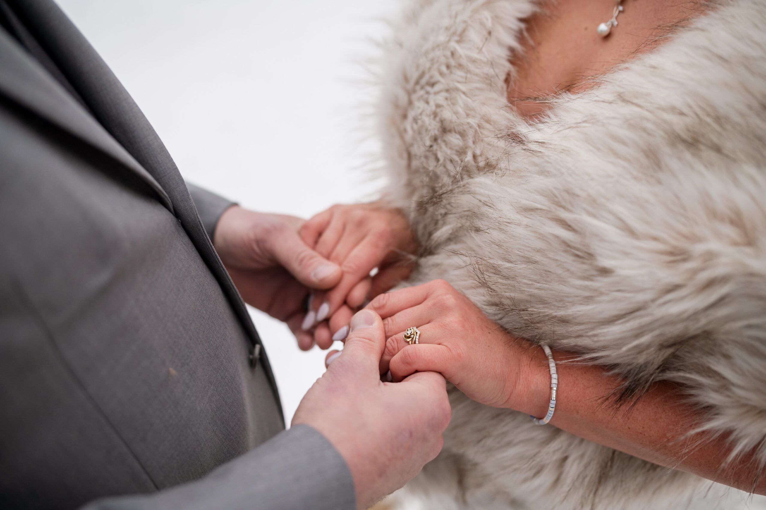 an up close shot of the couples hands  at their Winter Elopement at Sprague Lake. 