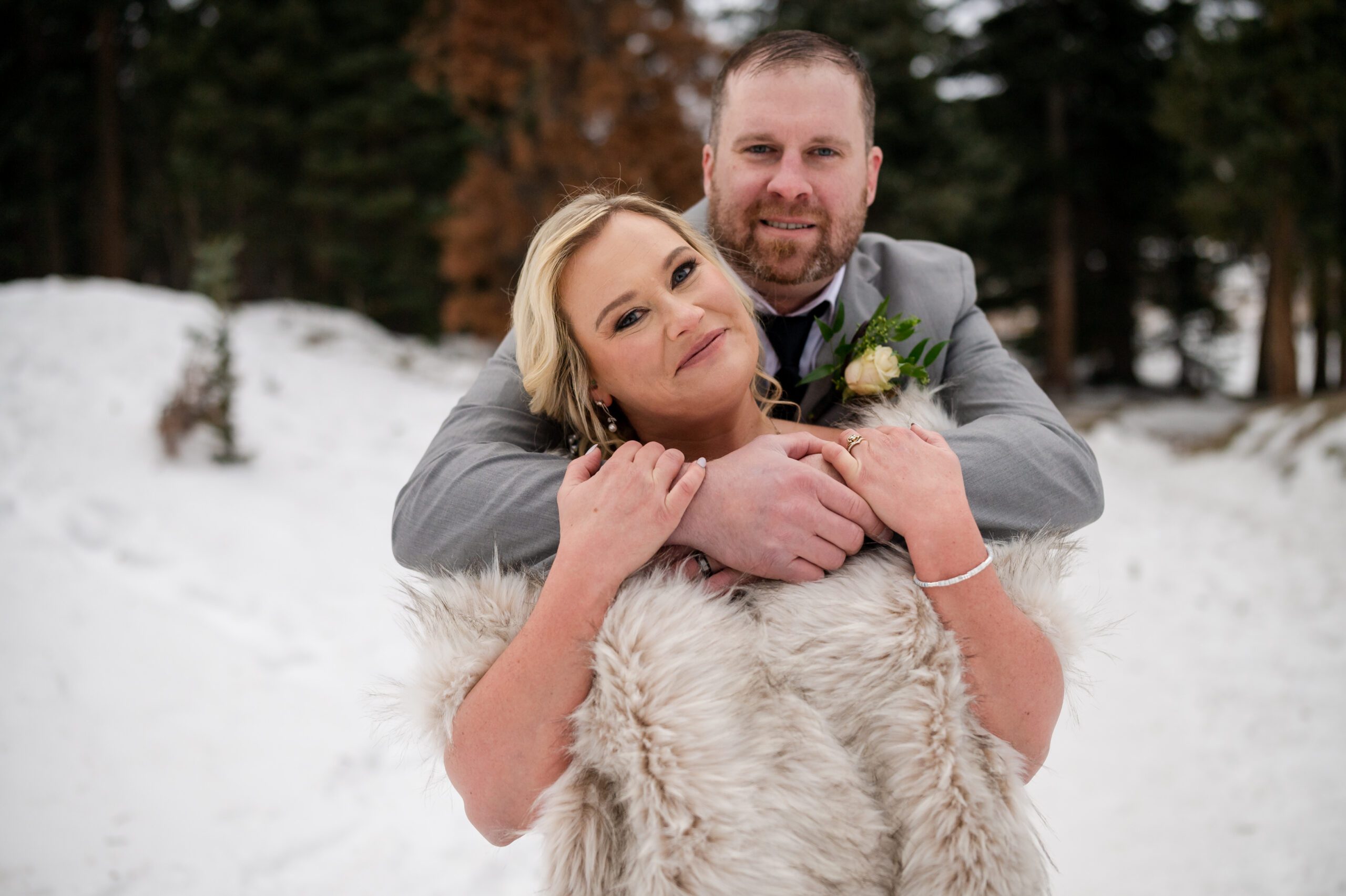 groom wraps his arms around his bride during their Winter Elopement at Sprague Lake. 
