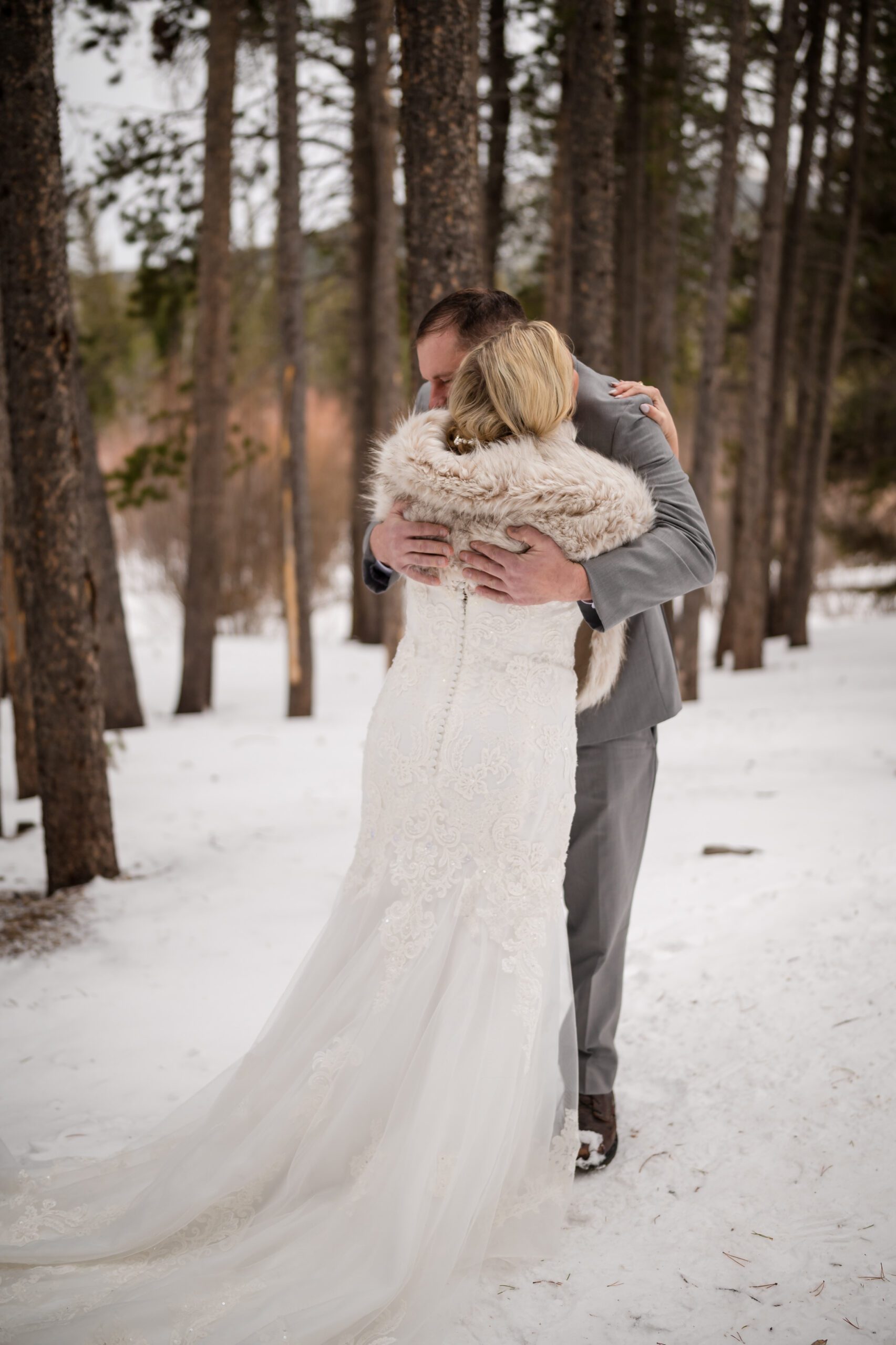 Bride and groom hug during their Winter Elopement at Sprague Lake after their first look. 